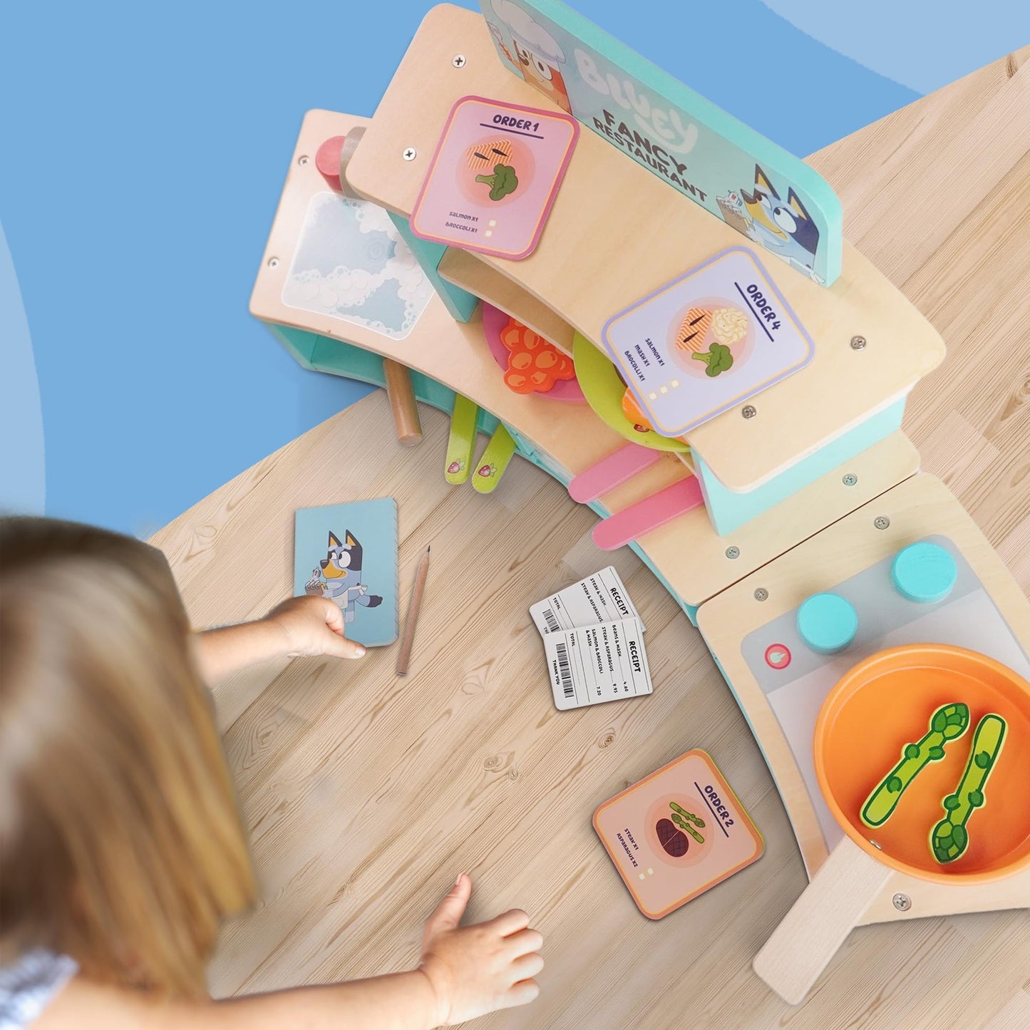 Bluey wooden tabletop restaurant playset with oven, sink, fridge, and accessories for kids' imaginative role play.