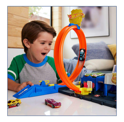 Hot Wheels Super Police Station playset with adjustable loop and 1:64 scale die-cast car on a vibrant track.