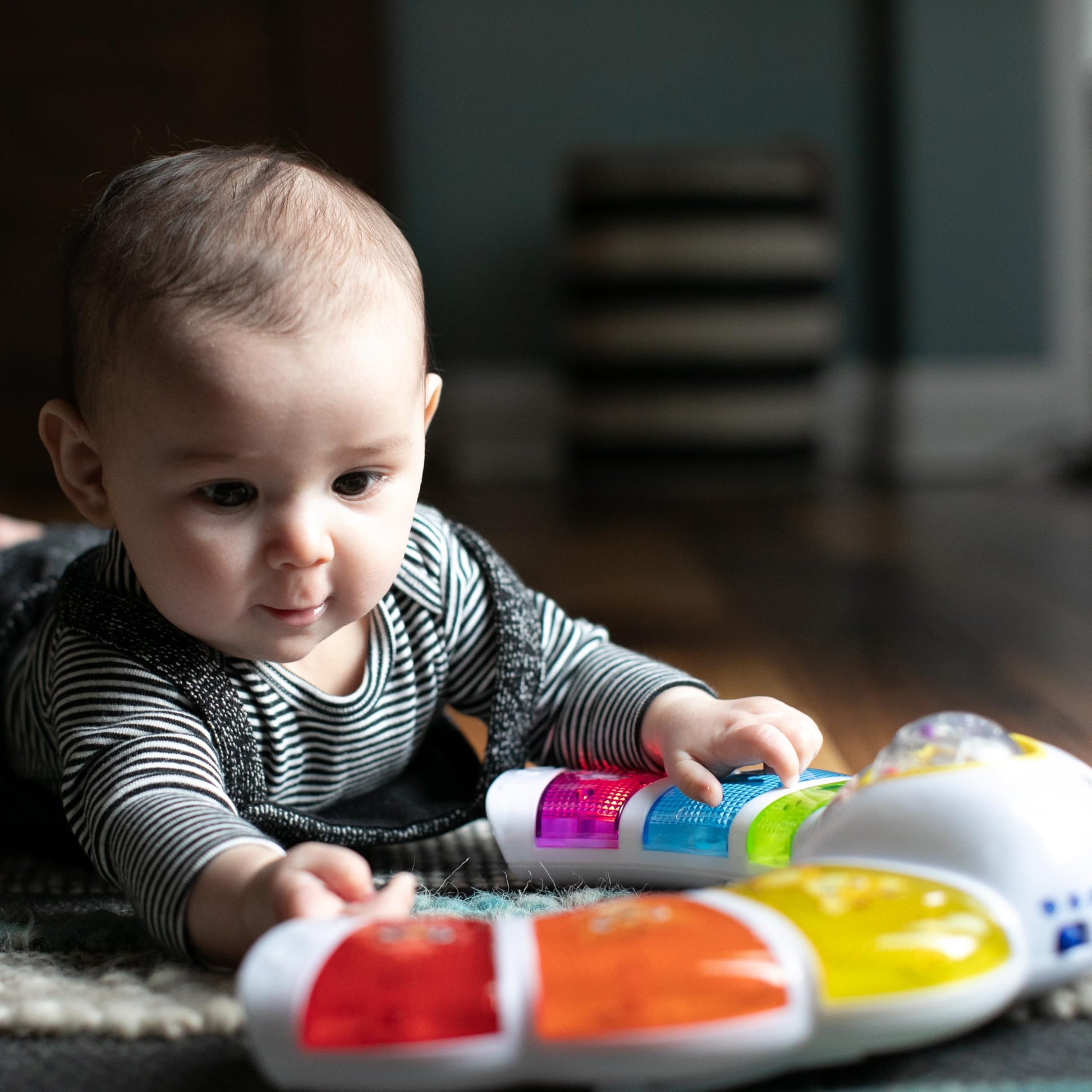 Baby Einstein Glow & Discover Light Bar musical activity station with colorful lights, buttons, and tummy time features for babies.