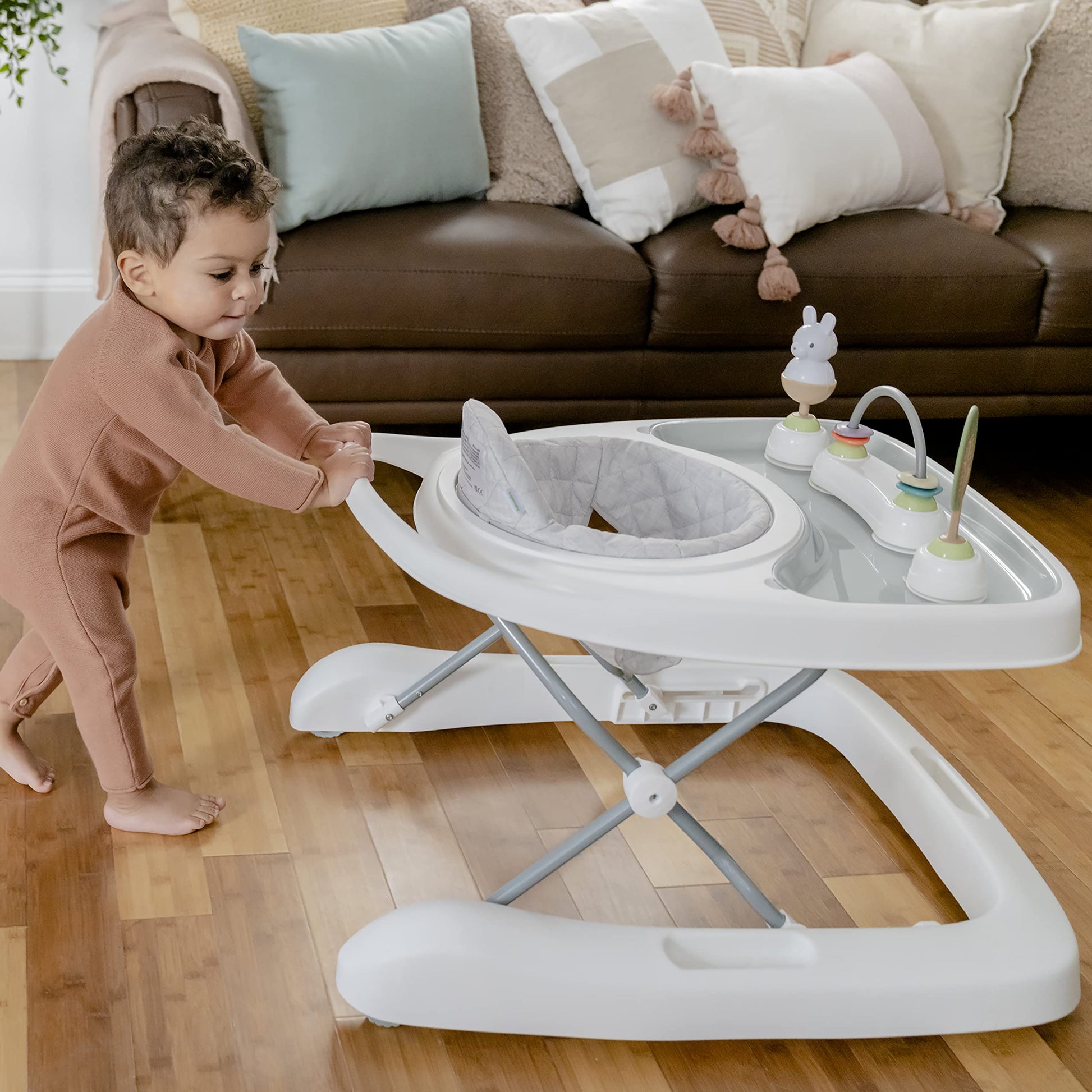 Ingenuity Spring & Sprout First Forest 3-in-1 baby activity walker with colorful toys, adjustable height, and foldable design.