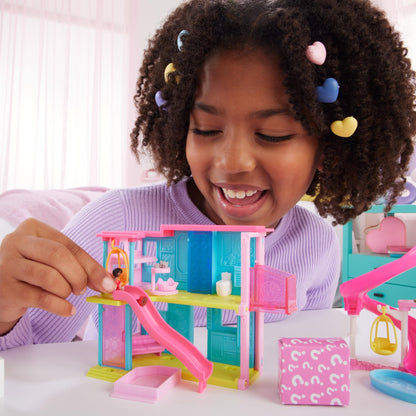 Mini Barbie Dreamhouse set with 1.5-inch Barbie doll, furniture, elevator, and pool, perfect for ages 4 and up.