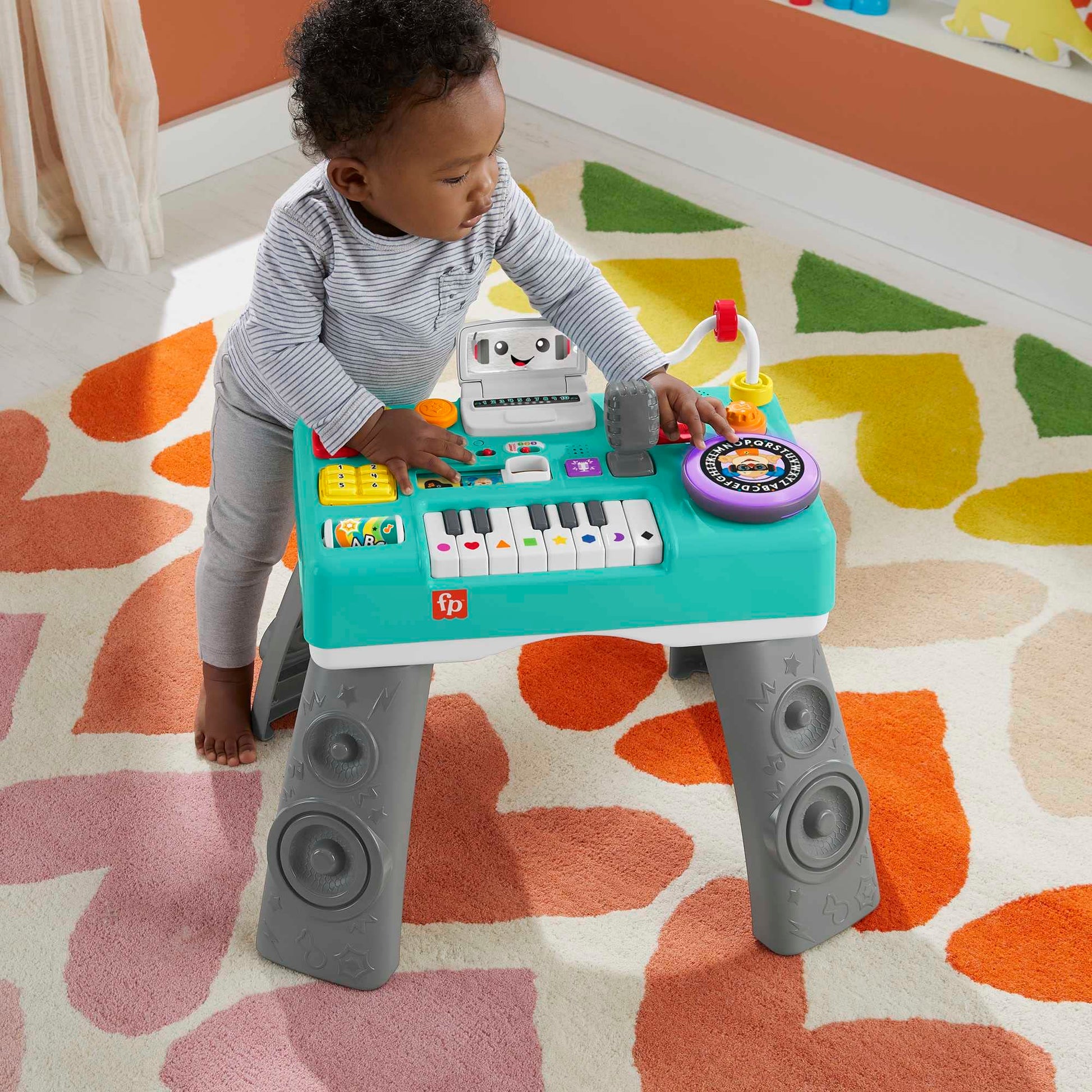 Fisher-Price Laugh & Learn DJ Activity Table for babies and toddlers with colorful lights, sounds, and musical features.