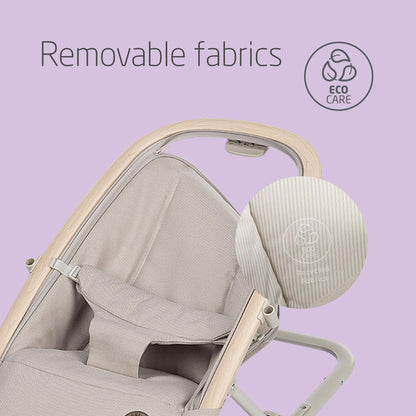 Maxi-Cosi Kori baby bouncer chair in classic beige with toy arch, adjustable recline, newborn pillow, and easy-in harness for infants.