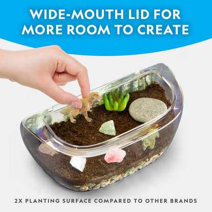 Blue Marble National Geographic Light Up Terrarium Kit for Kids showing a dinosaur habitat with real plants, gemstones, and dinosaur toys.