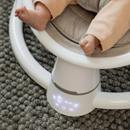 Nuby Connect baby swing chair in grey with toy bar, canopy, remote control, suitable from birth, featuring a soft padded seat.