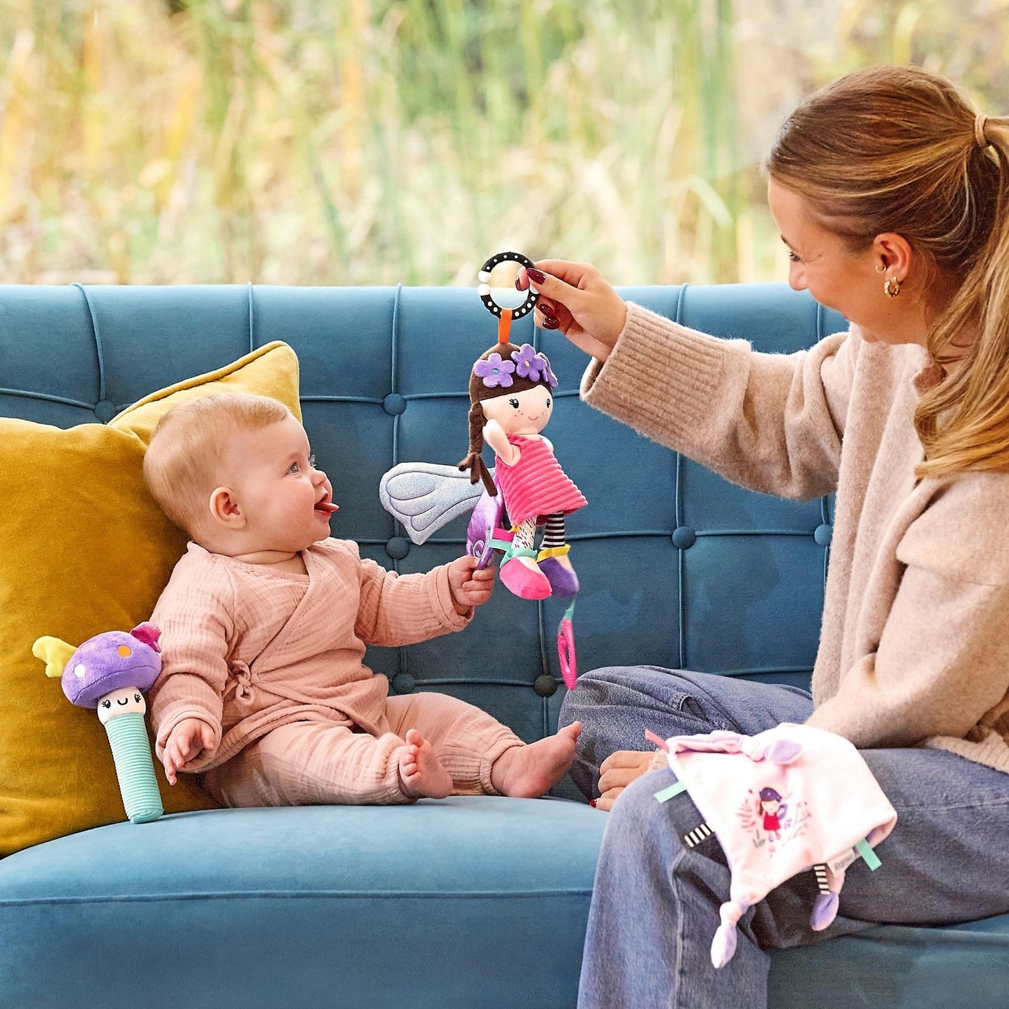 Colorful Nuby Things with Wings baby pram toy featuring a baby-safe mirror, teething elements, and a universal clip for ease of attachment.