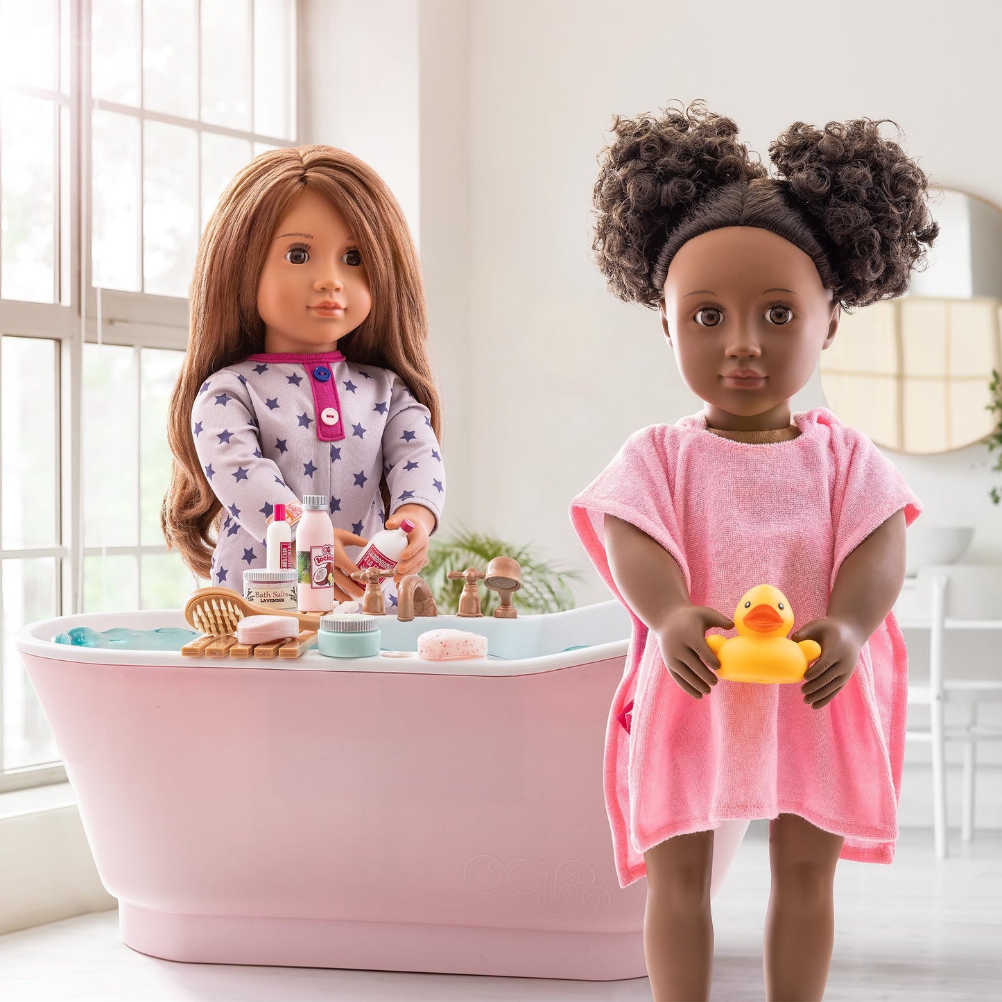 Our Generation Maria doll in pyjama onesie holding elephant plush toy, posable fashion doll for ages 3 to 12.