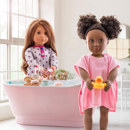 Our Generation Maria doll in pyjama onesie holding elephant plush toy, posable fashion doll for ages 3 to 12.