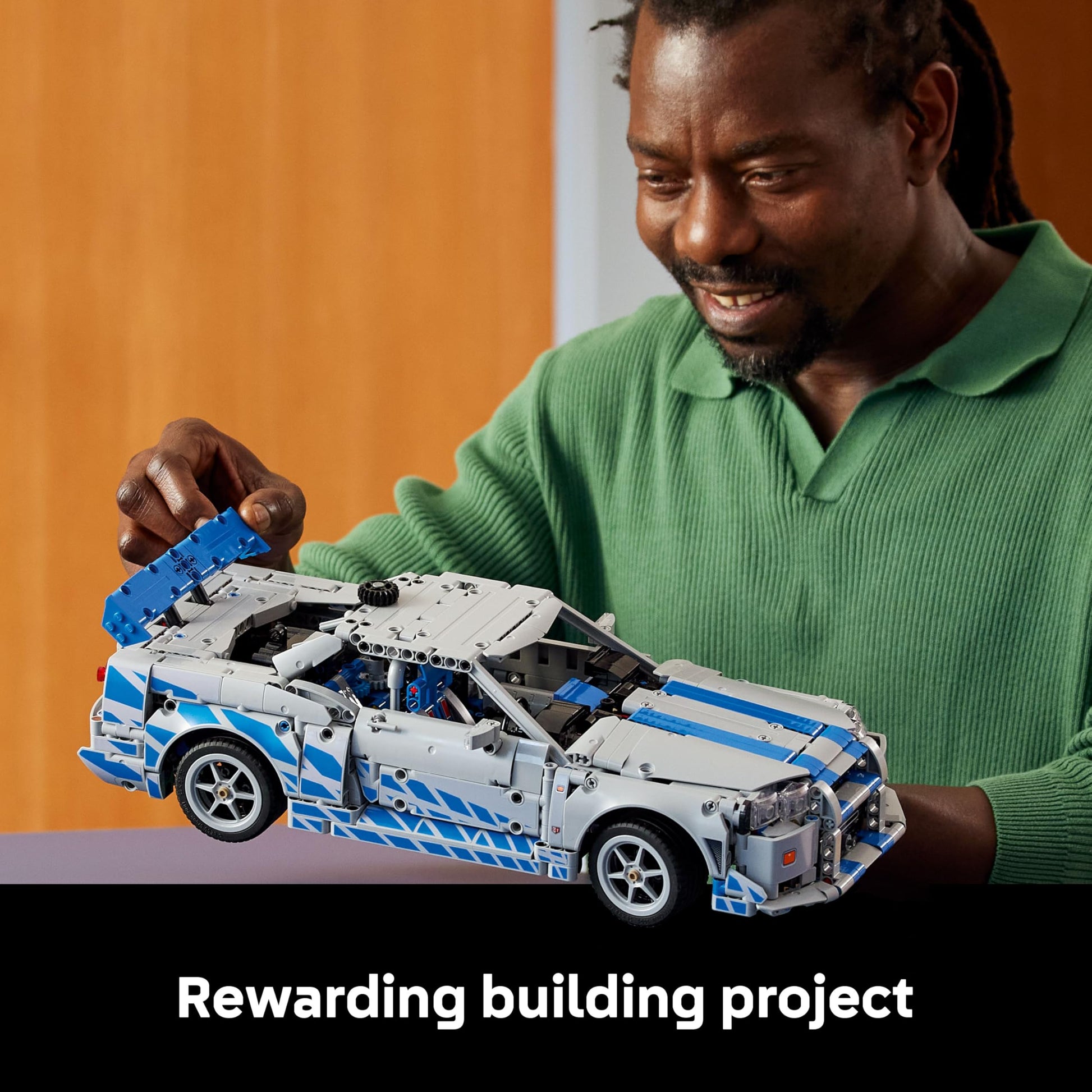 LEGO Technic Nissan Skyline GT-R (R34) model kit showcasing drift function, steering, and detailed 6-cylinder engine.