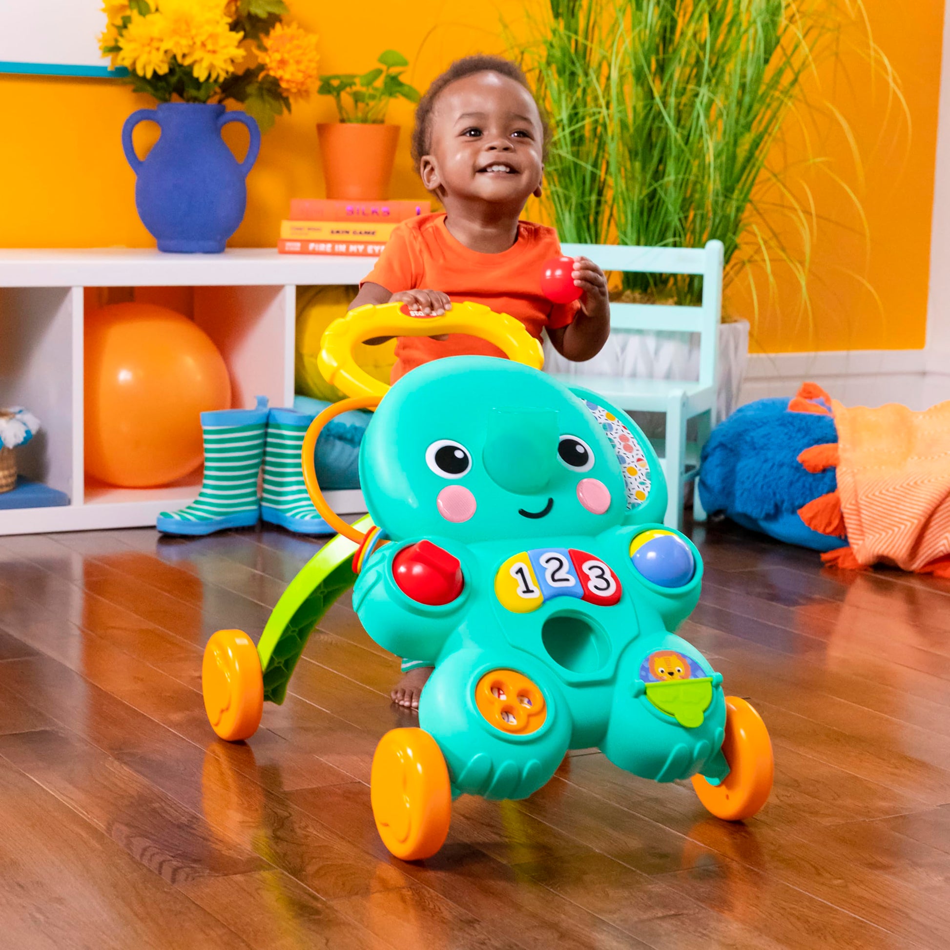 Bright Starts Stroll 'N Roll 2-in-1 Elephant Ball Play Walker with lights and music for babies 6 months and older.
