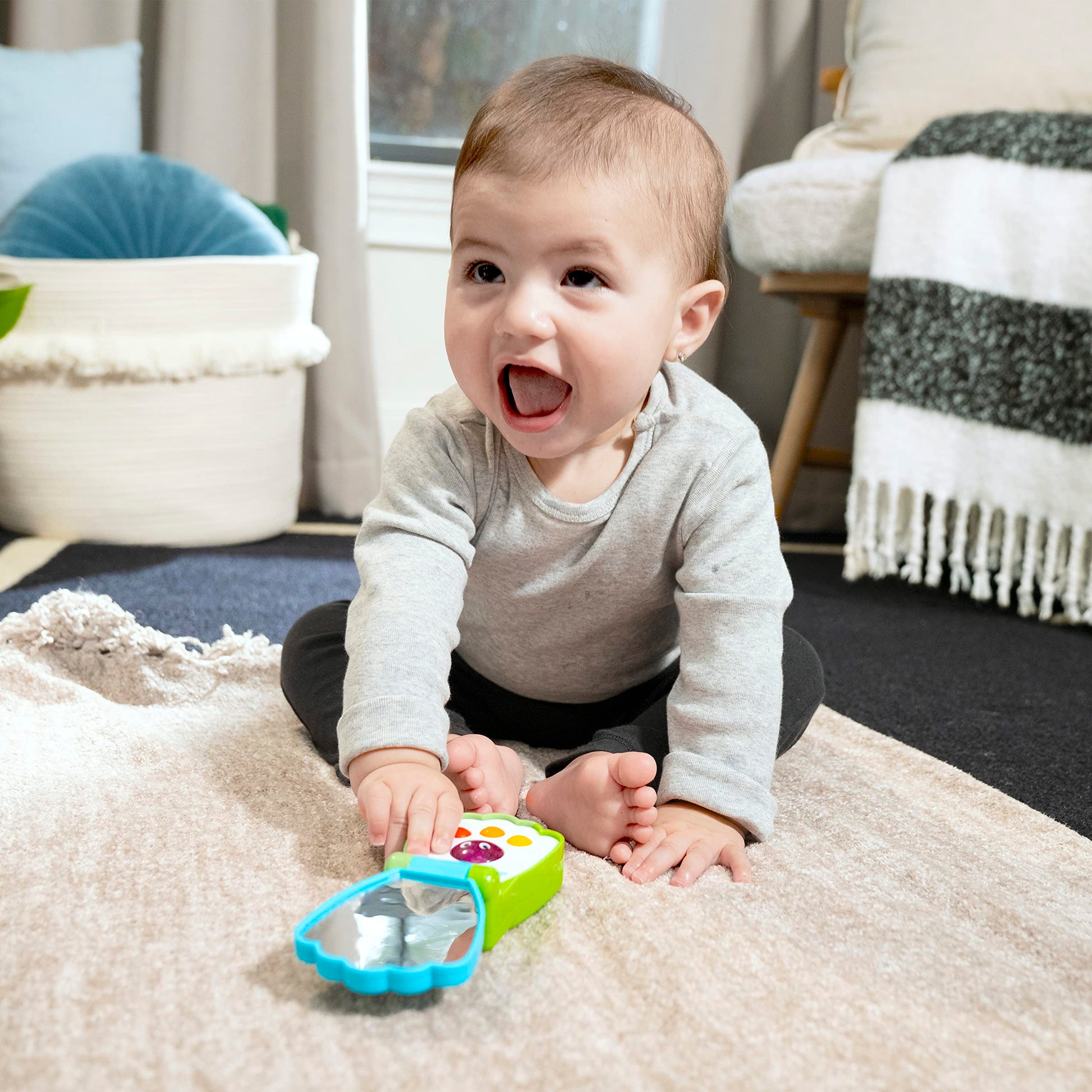 Baby Einstein Ocean Explorers shell-shaped musical toy phone for babies age 6 months and up, featuring colorful ocean-themed design.