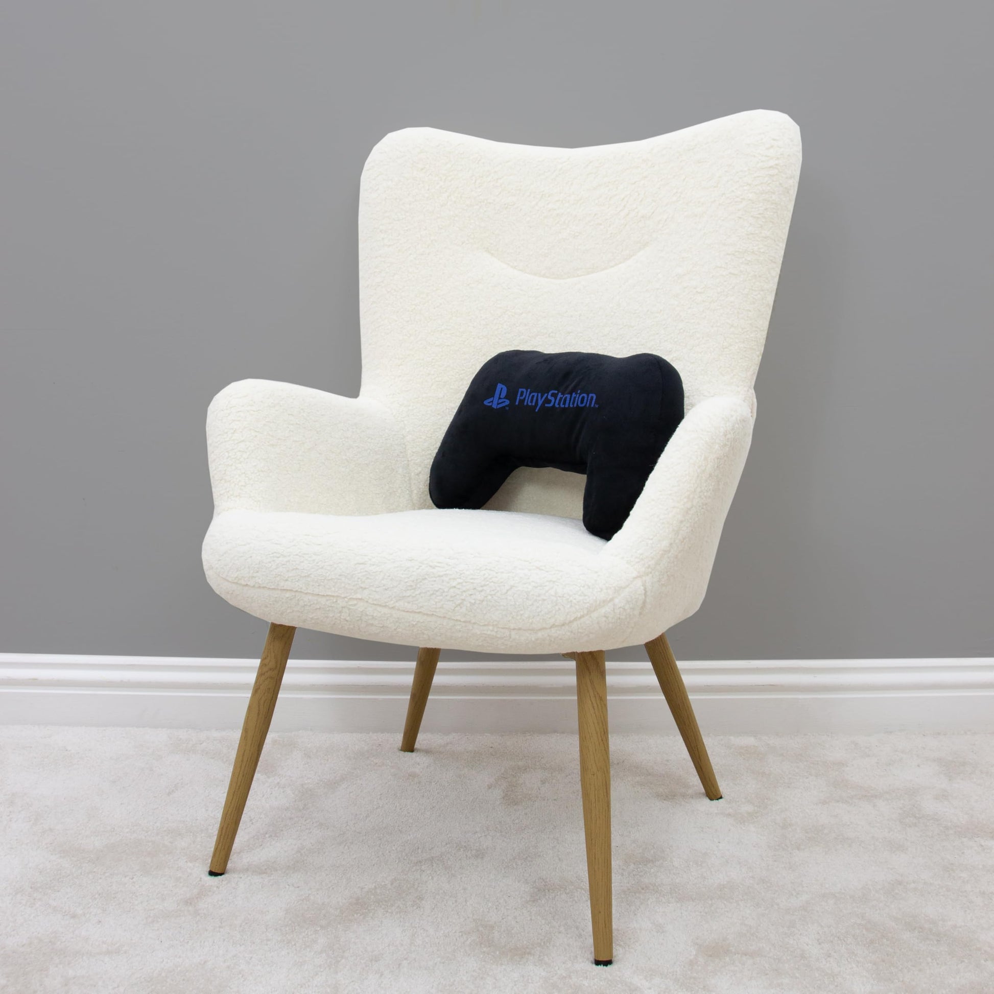Black PlayStation controller-shaped plush cushion pillow, glow-in-the-dark design, perfect for bedroom or gaming décor.