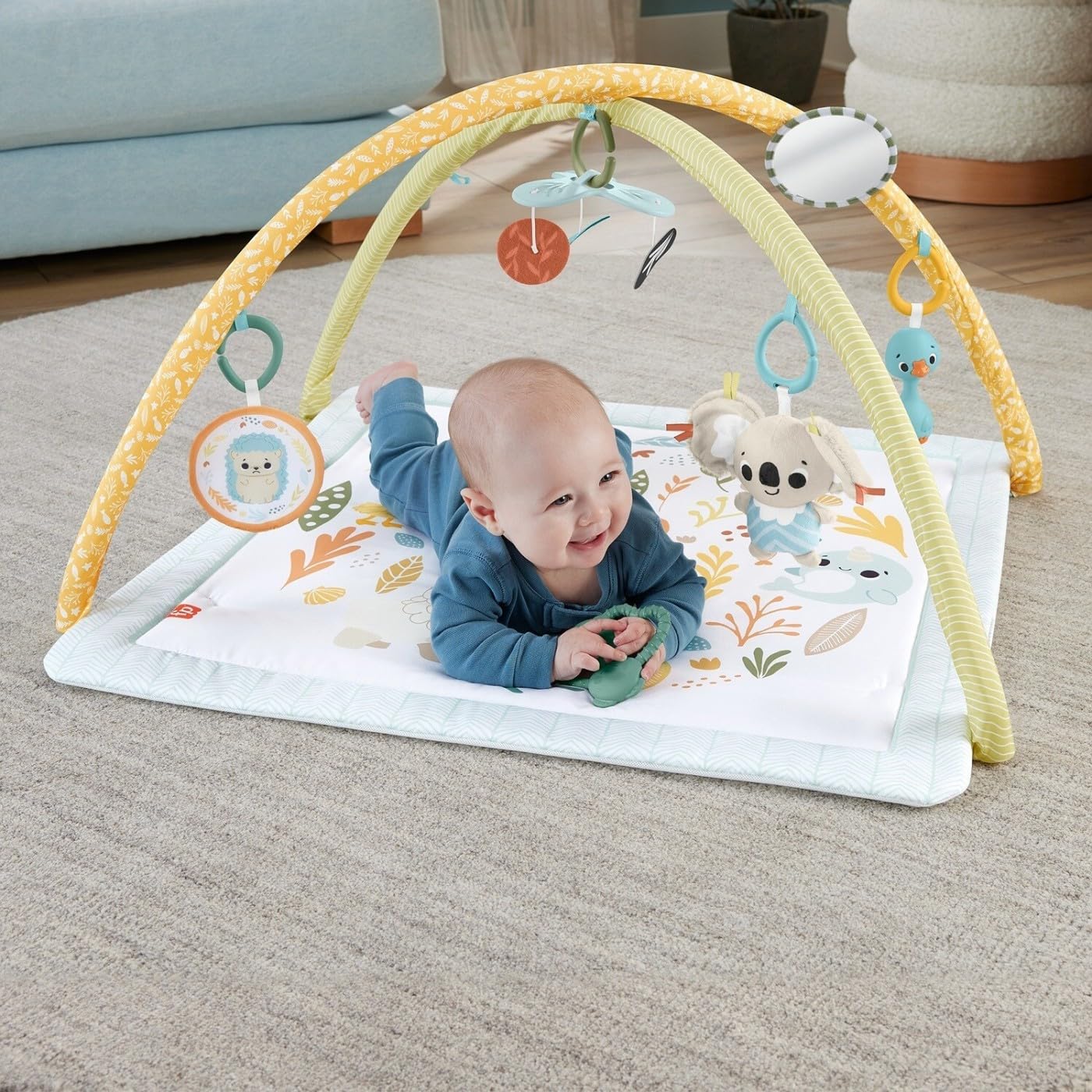 Fisher-Price Baby Playmat Simply Senses newborn gym with colorful mobile and sensory toys for developmental play for ages 0+ months.