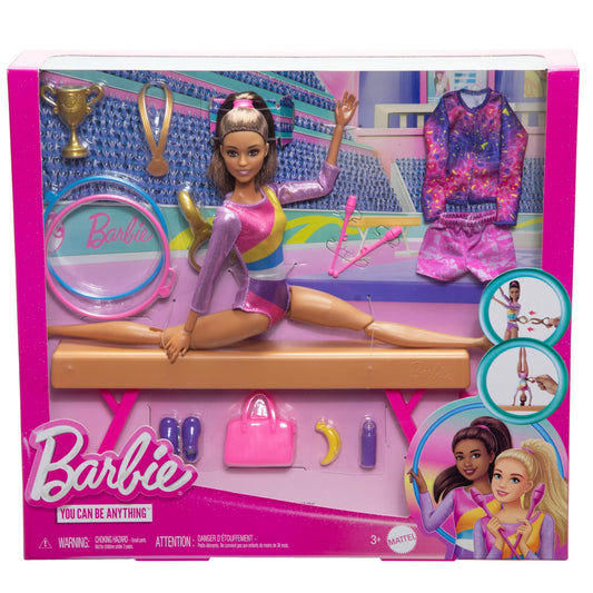 Barbie gymnastics doll in warm-up suit with balance beam and accessories for flipping action, showcasing brunette hair.