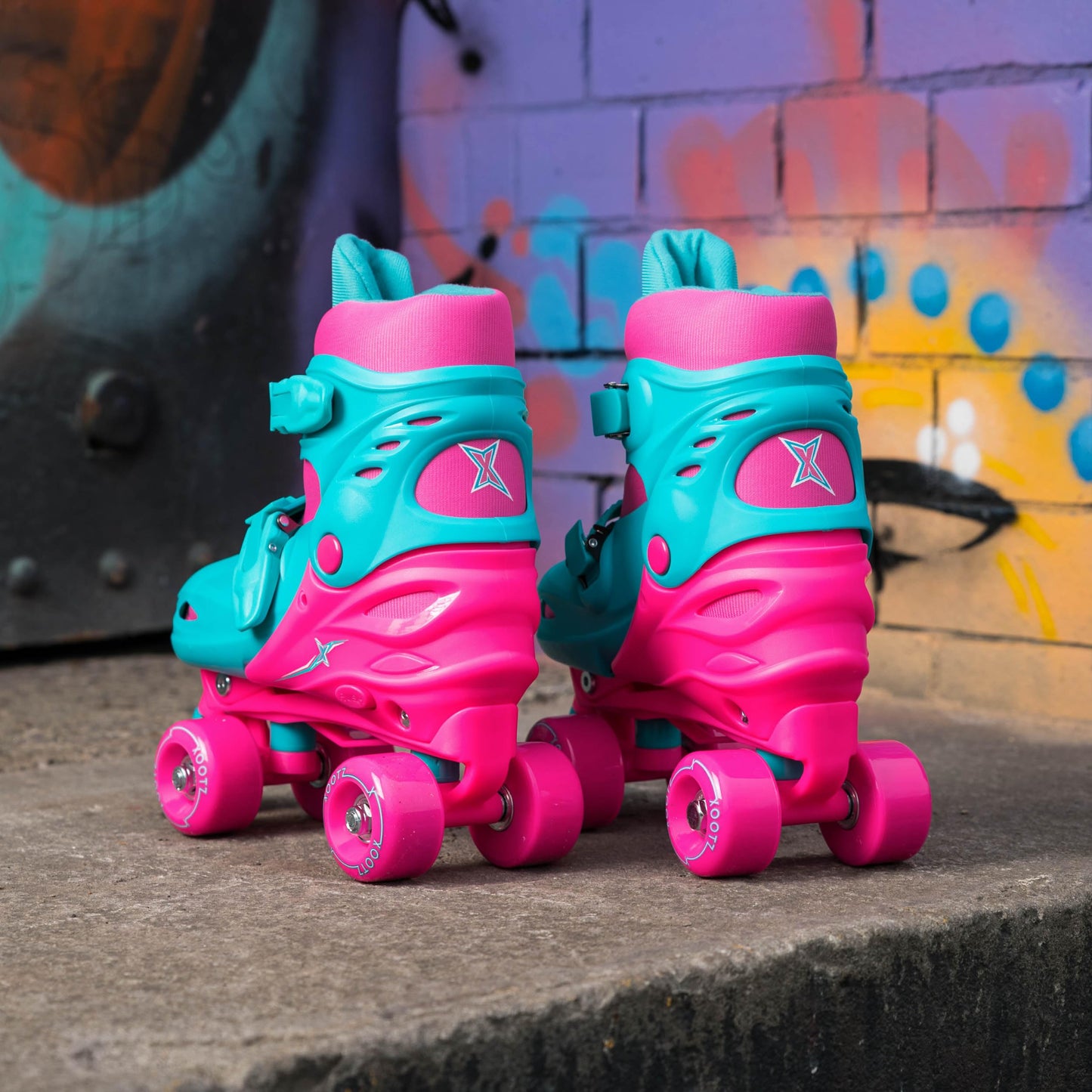 Pink Xootz kids quad roller skates for girls, adjustable beginner skates with four wheels and supportive ankle straps.
