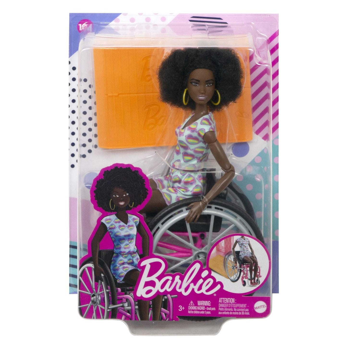 Barbie Fashionistas doll with curly black hair in a rainbow heart romper, seated in a wheelchair beside a ramp.