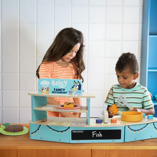 Bluey Tabletop Restaurant Playset with wooden oven, sink, fridge, and accessories for kids aged 3+ in a colorful pretend kitchen setting.