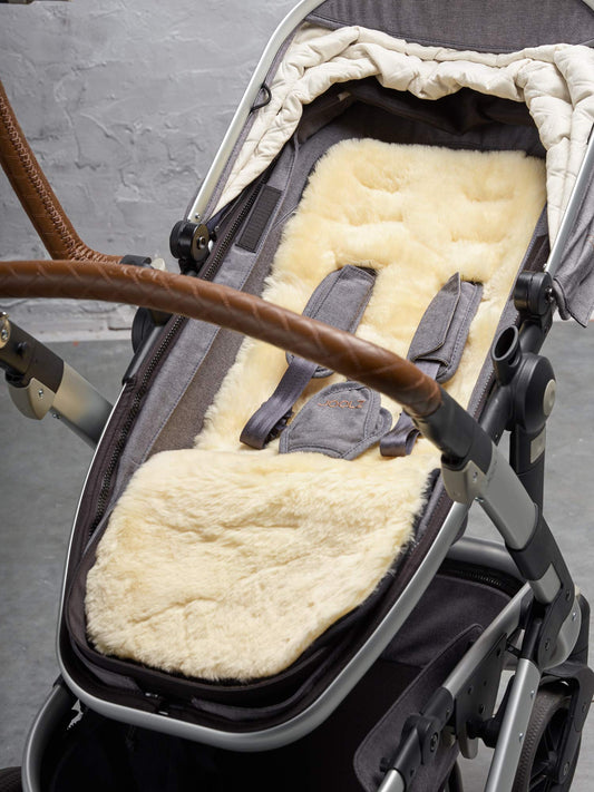 Naturally Sheepskins Merino pram liner made of natural New Zealand sheepskin with cotton backing, breathable and temperature regulating for baby.