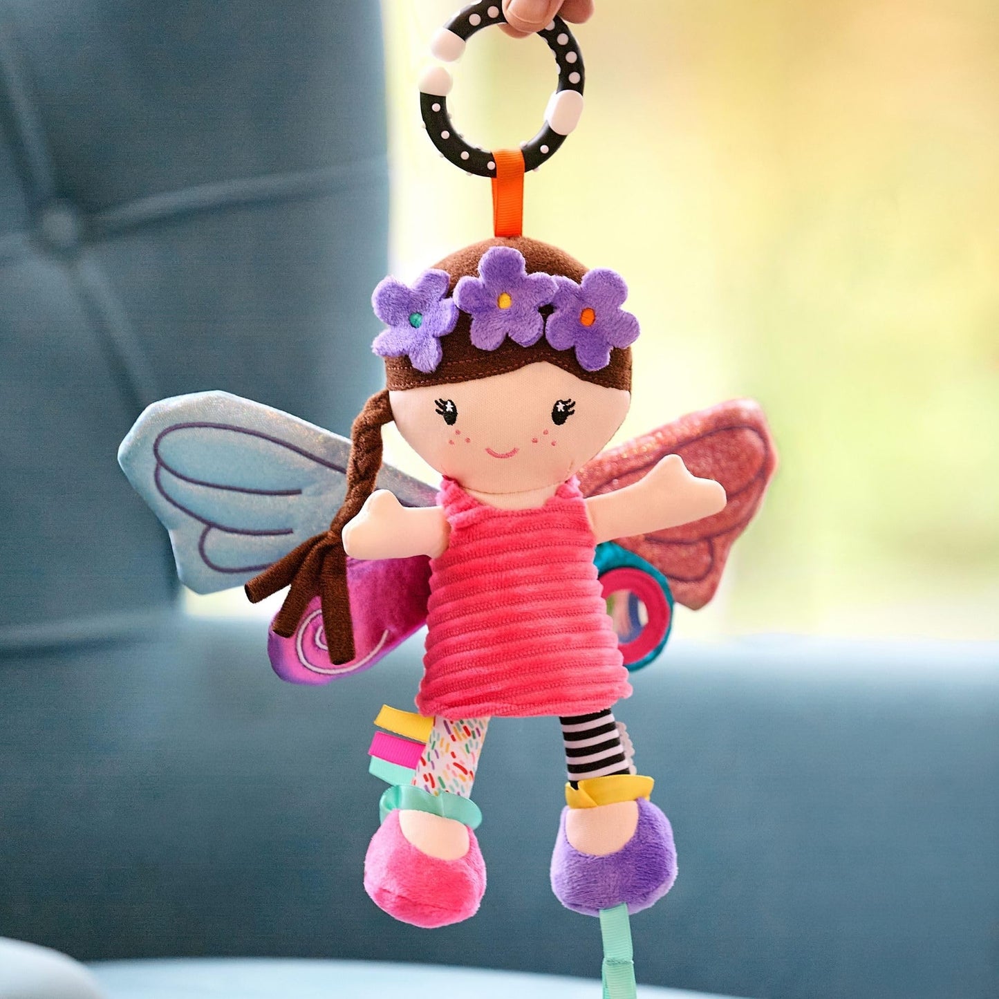 Colorful Nuby Things with Wings baby pram toy featuring a baby-safe mirror, teether, and universal clip for sensory fun.