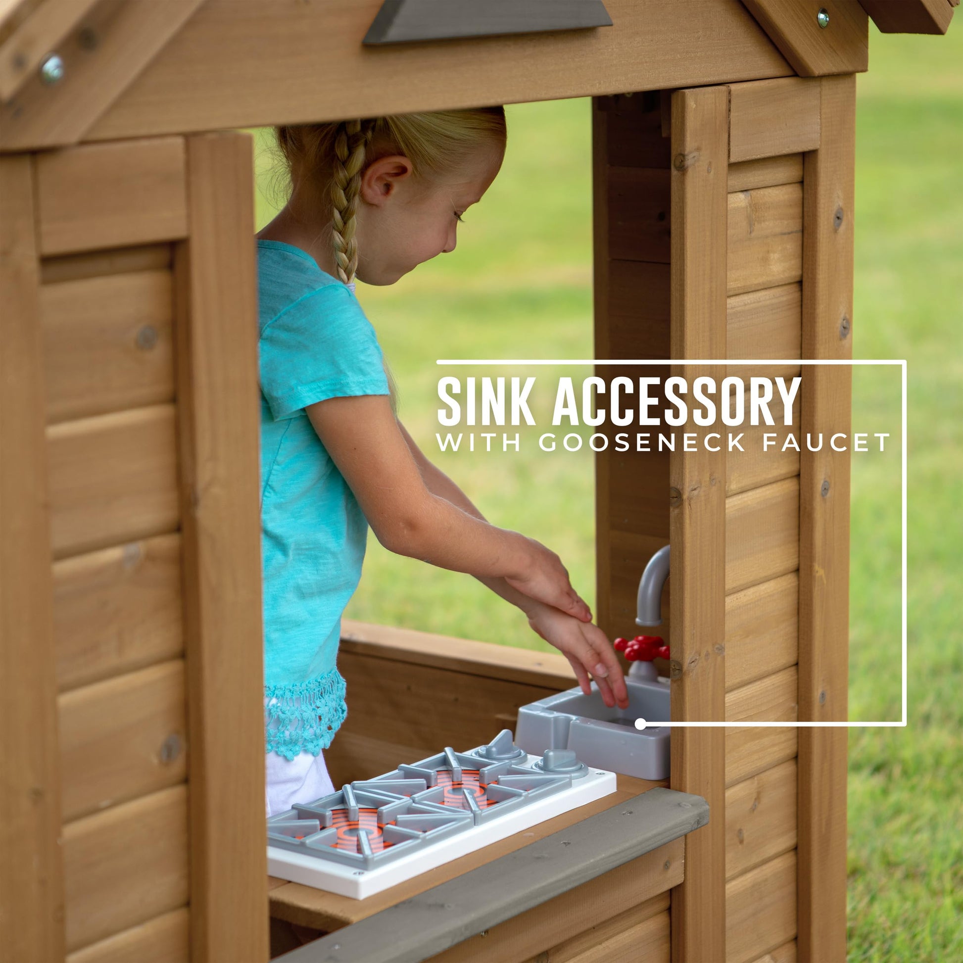 Backyard Discovery cedar wood children's playhouse with play kitchen, snack bar window, and half door in a backyard setting