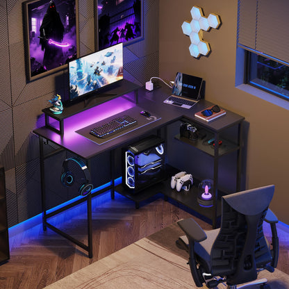 DEVAISE L-shaped gaming desk in black with RGB LED lights, monitor stand, hook, and storage shelf for home office or gaming setup