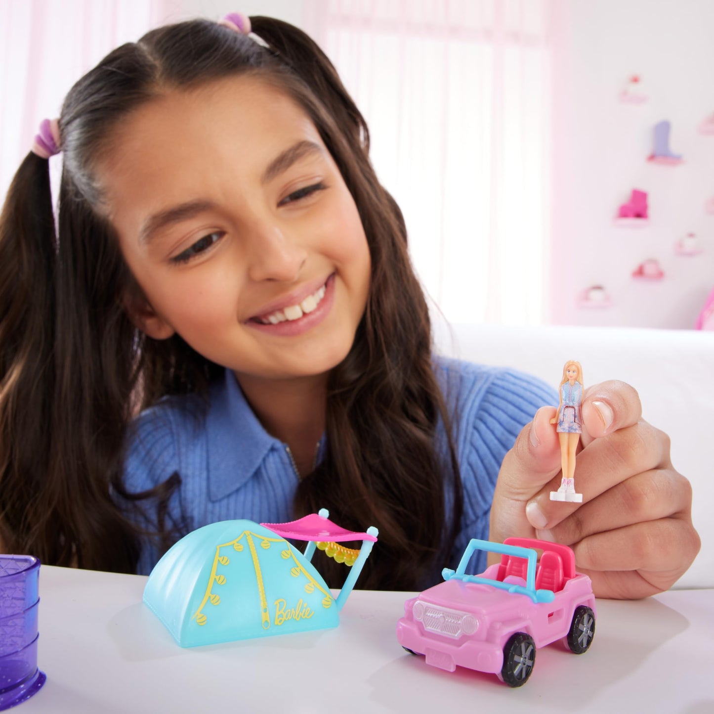 Mini BarbieLand doll and toy vehicle set including 1.5-inch Barbie doll, color-change SUV, and tent accessory by Barbie.