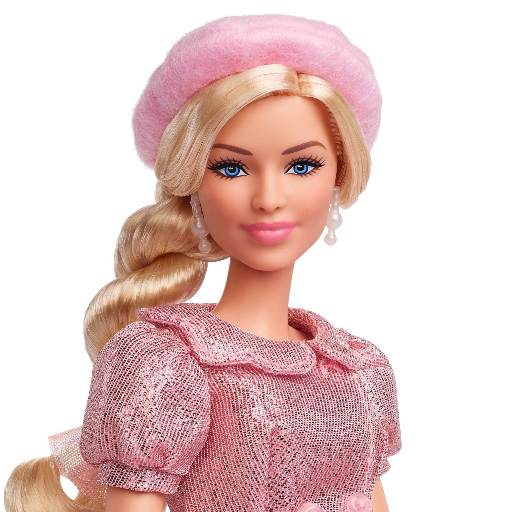 Barbie collectible doll of Margot Robbie in pink blouse and tutu skirt, featuring styled hair and matching jewelry.