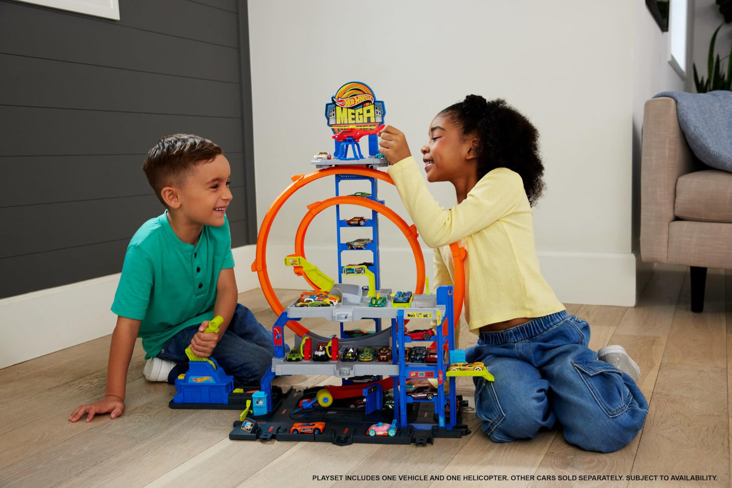Hot Wheels toy car track set featuring two loops, storage for 37 cars, and a die-cast car and helicopter.