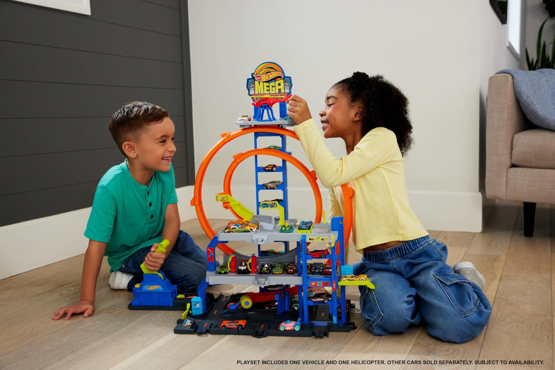Hot Wheels toy car track set featuring two loops, storage for 37 cars, and a die-cast car and helicopter.