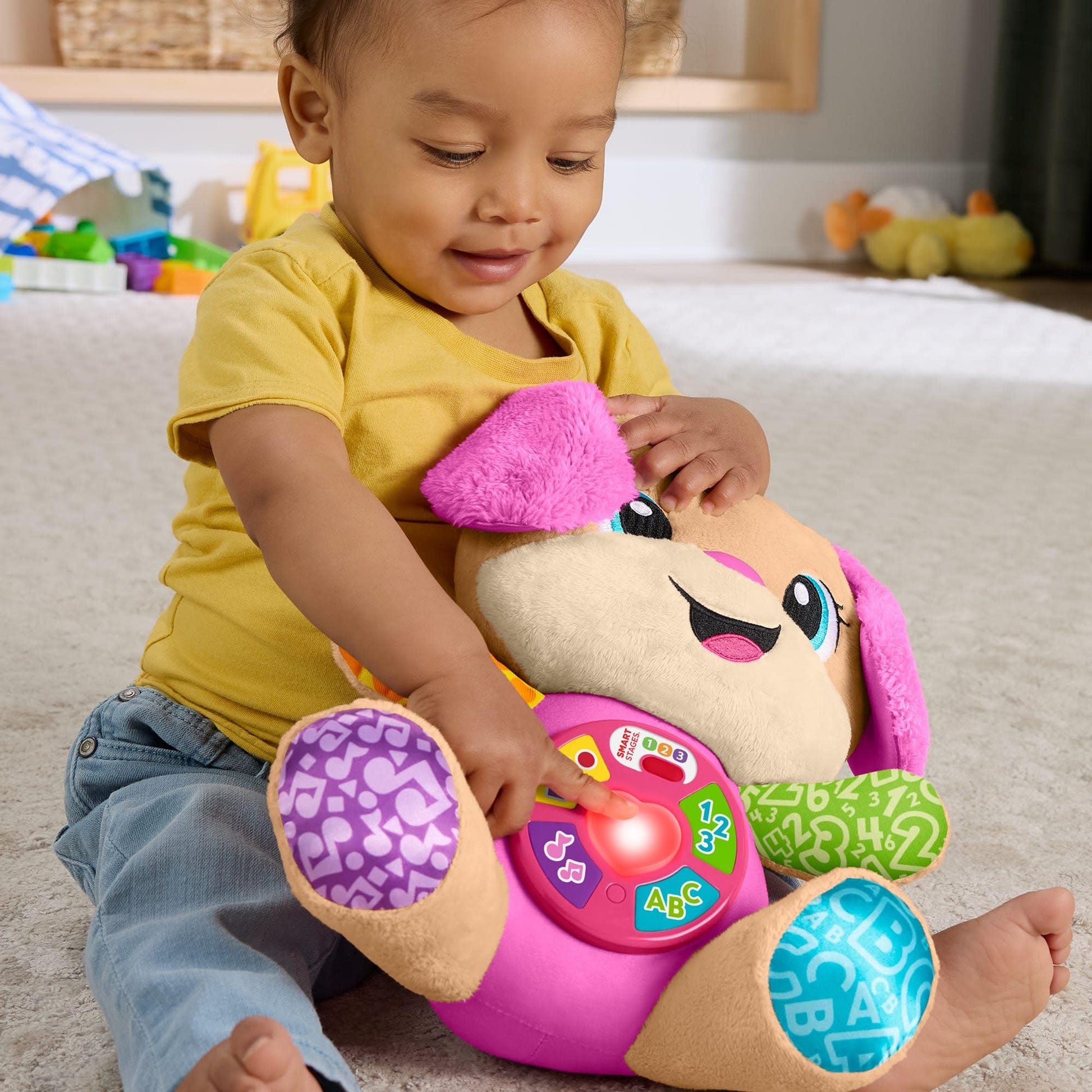 Fisher-Price Laugh & Learn Smart Stages Pink musical plush toy for infants with multilingual features, suitable for ages 6+ months.