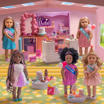 18-inch Our Generation doll party accessories featuring a birthday cake and colorful balloons for imaginative play.