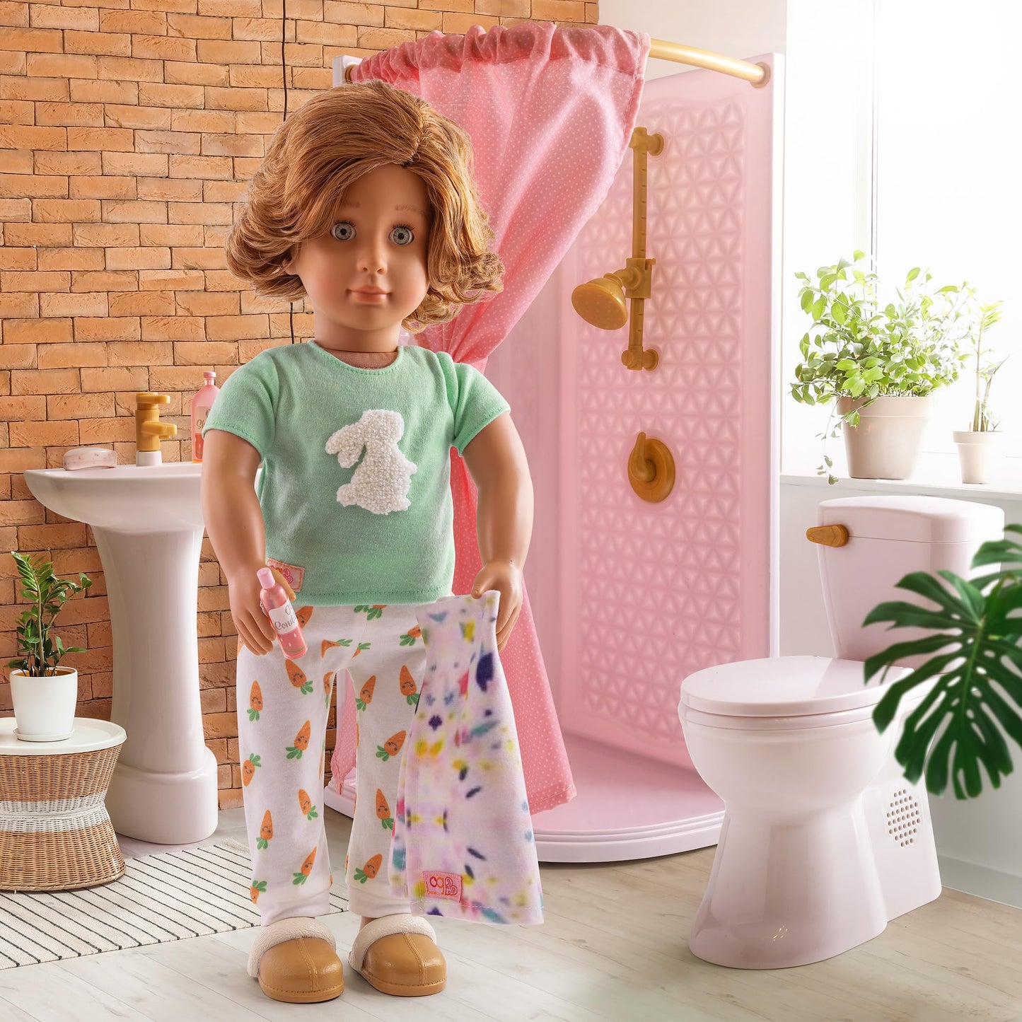 Our Generation dollhouse bathroom set with modern accessories for 18-inch dolls, featuring a stylish bathtub and sink.