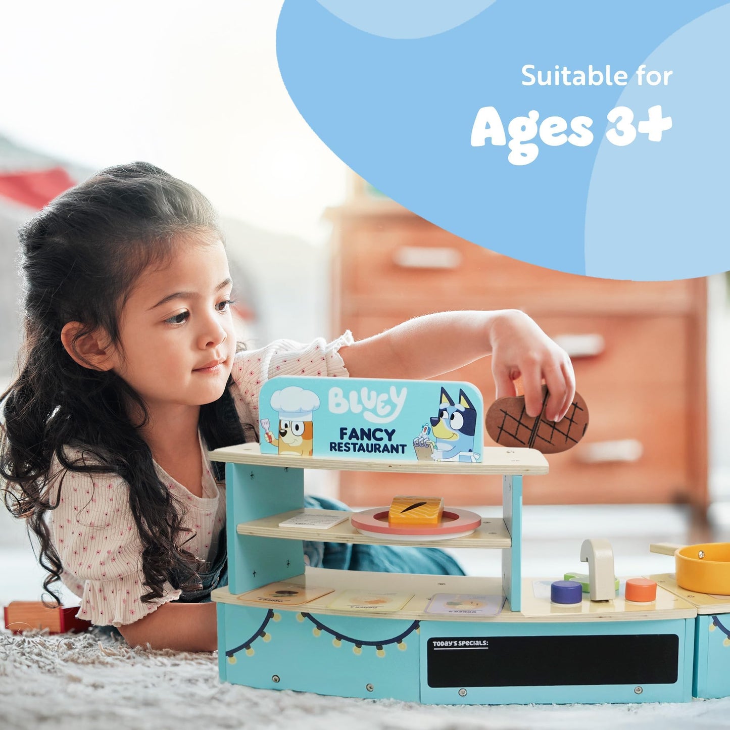 Bluey tabletop restaurant playset for kids featuring a wooden pretend kitchen with oven, sink, fridge, and cooking accessories.