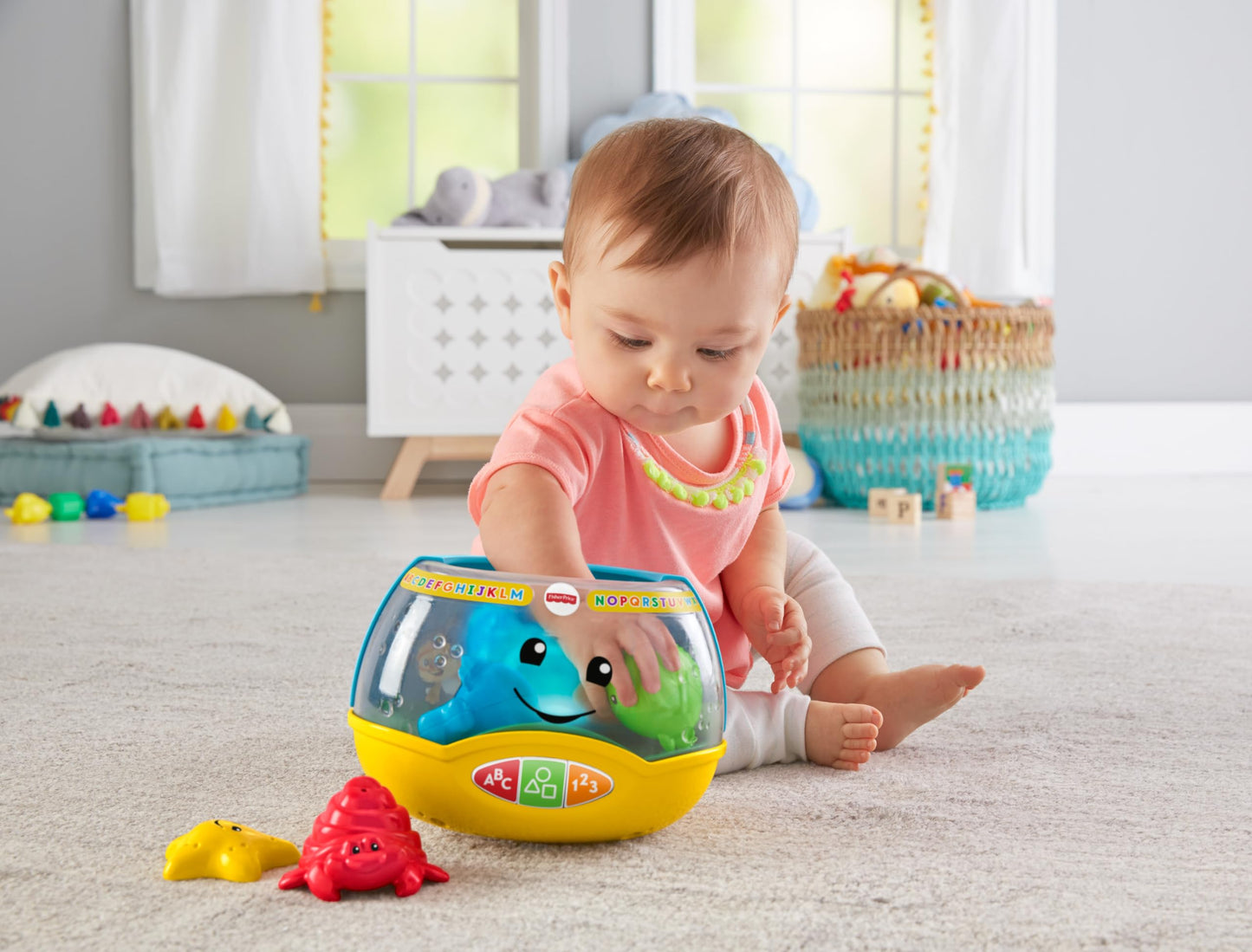 Fisher-Price Laugh & Learn Magical Lights Fishbowl toy with colorful fish and lights for infants 6 months and older.