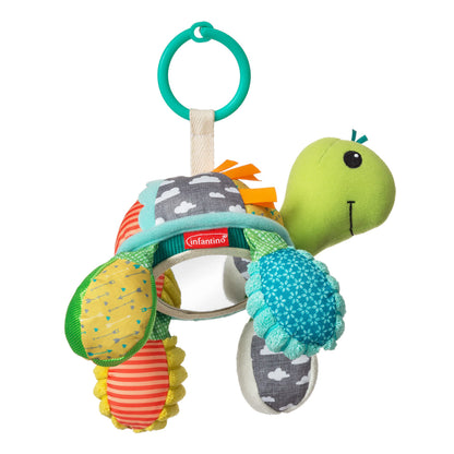 Infantino Go Gaga Turtle activity mirror clipped to a stroller for tummy time and sensory play with a newborn baby.