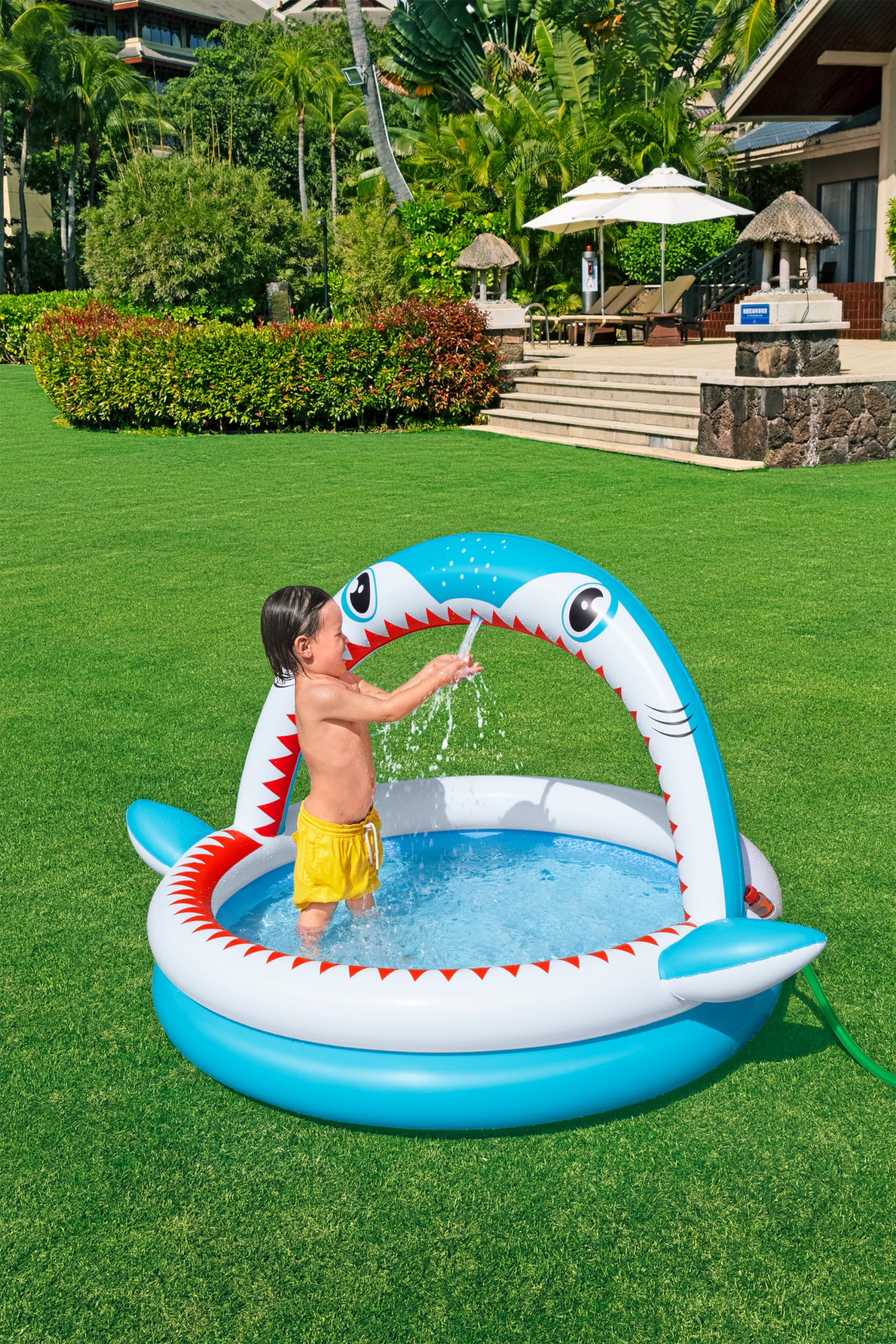 Bestway Shark Kids Inflatable Sprinkler Play Pool, featuring vibrant shark design and water sprayer, 1.63m x 1.27m x 92cm.