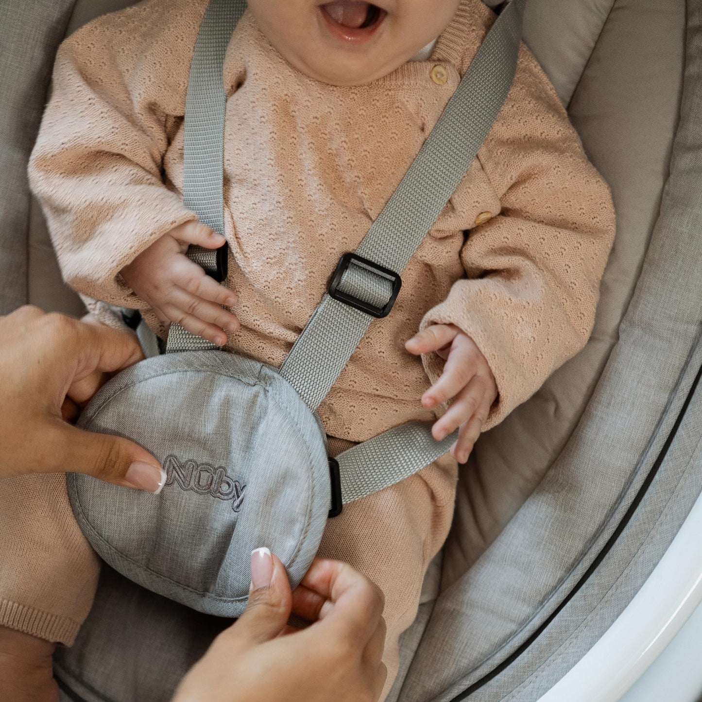 Nuby Connect baby swing chair in grey with toy bar, canopy, remote control, and musical bouncer for infants from birth.