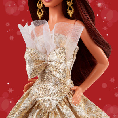 Barbie Signature 2025 Holiday fashion doll with dark brown hair in a silver and gold gown, displayed in collectible packaging.
