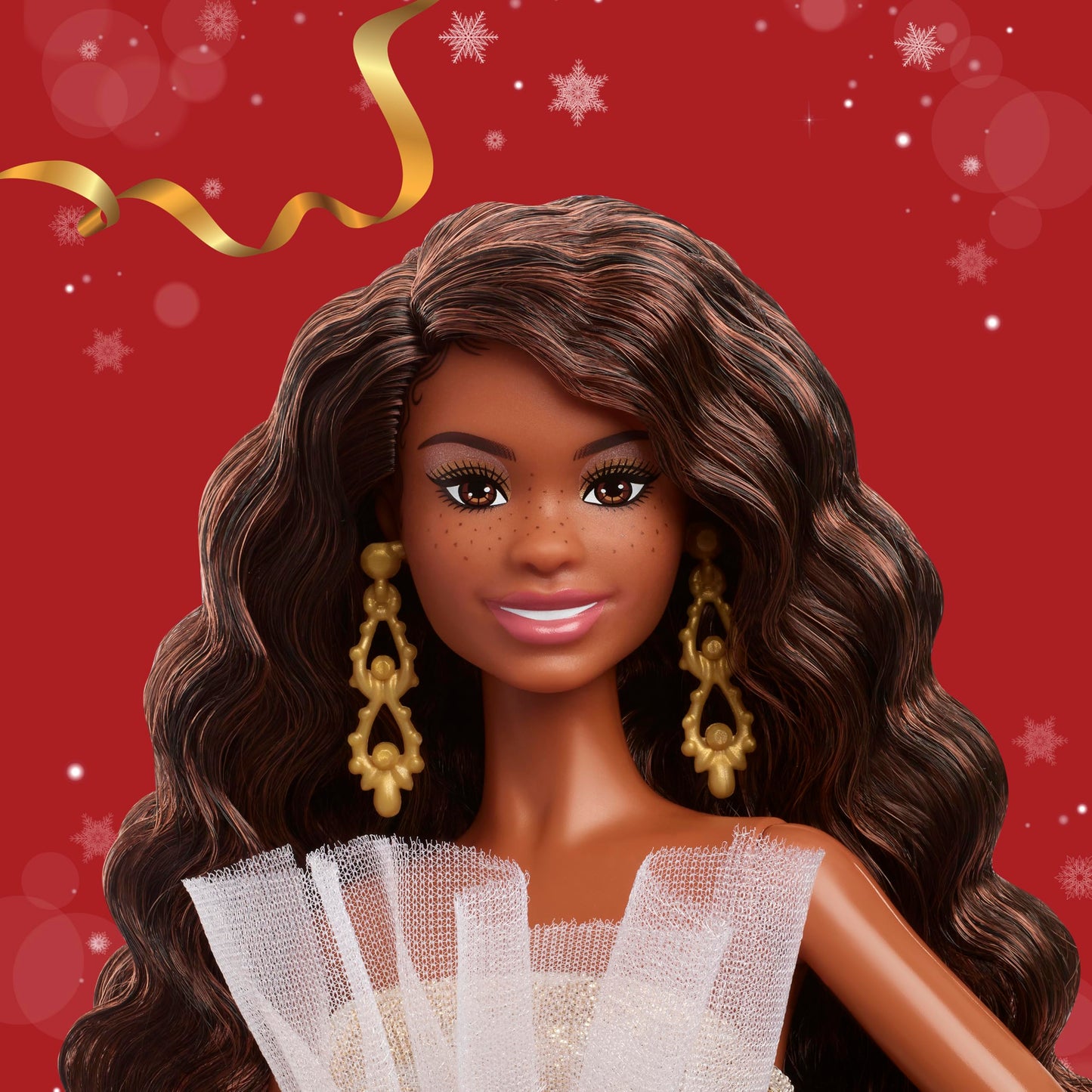 Barbie Signature 2025 Holiday fashion doll with black hair in a silver and gold gown, displayed in collectible packaging.