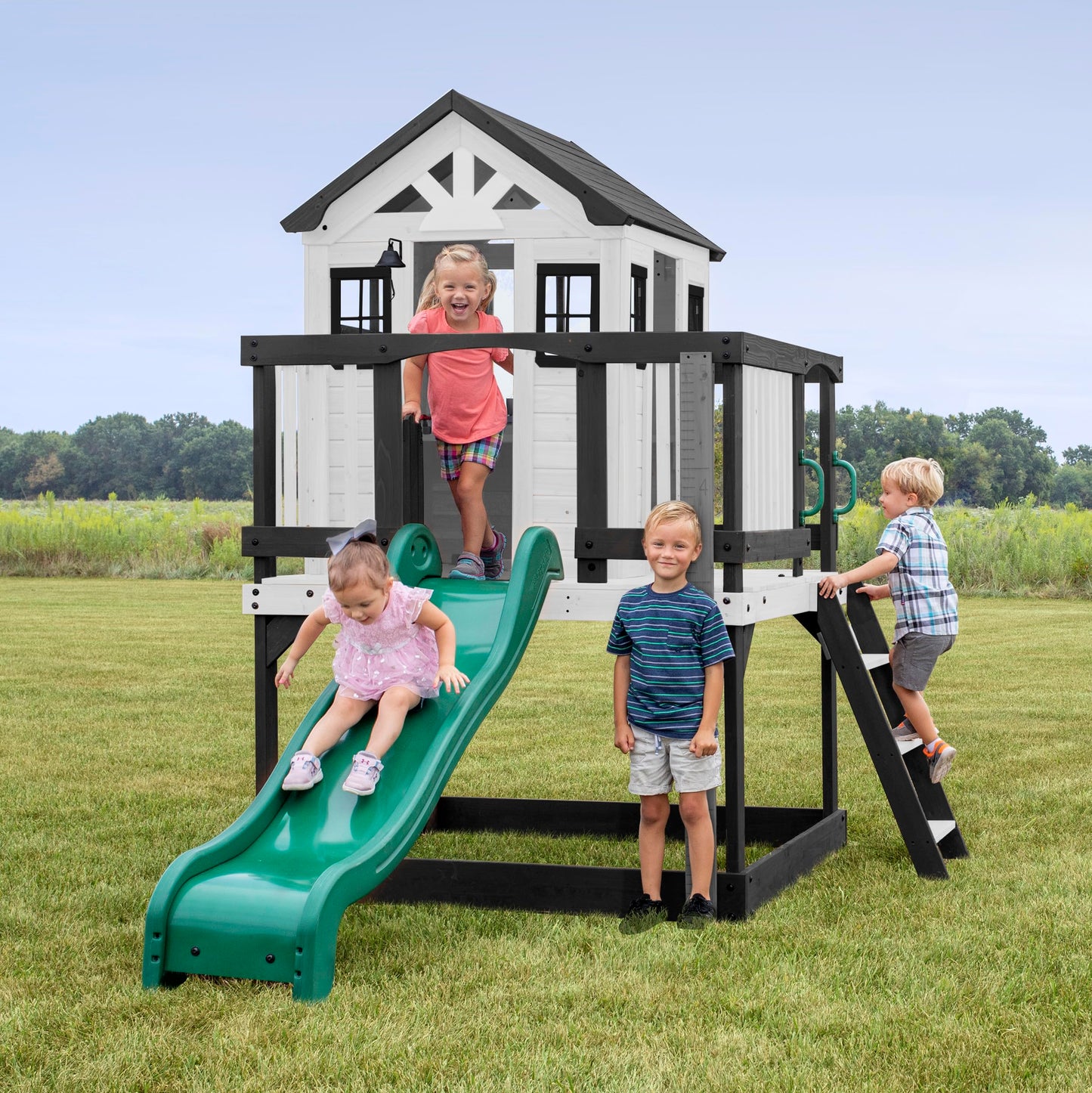 Backyard Discovery Sweetwater Heights cedar wood playhouse with wave slide, toy kitchen, growth chart, and compact design for kids' outdoor fun.