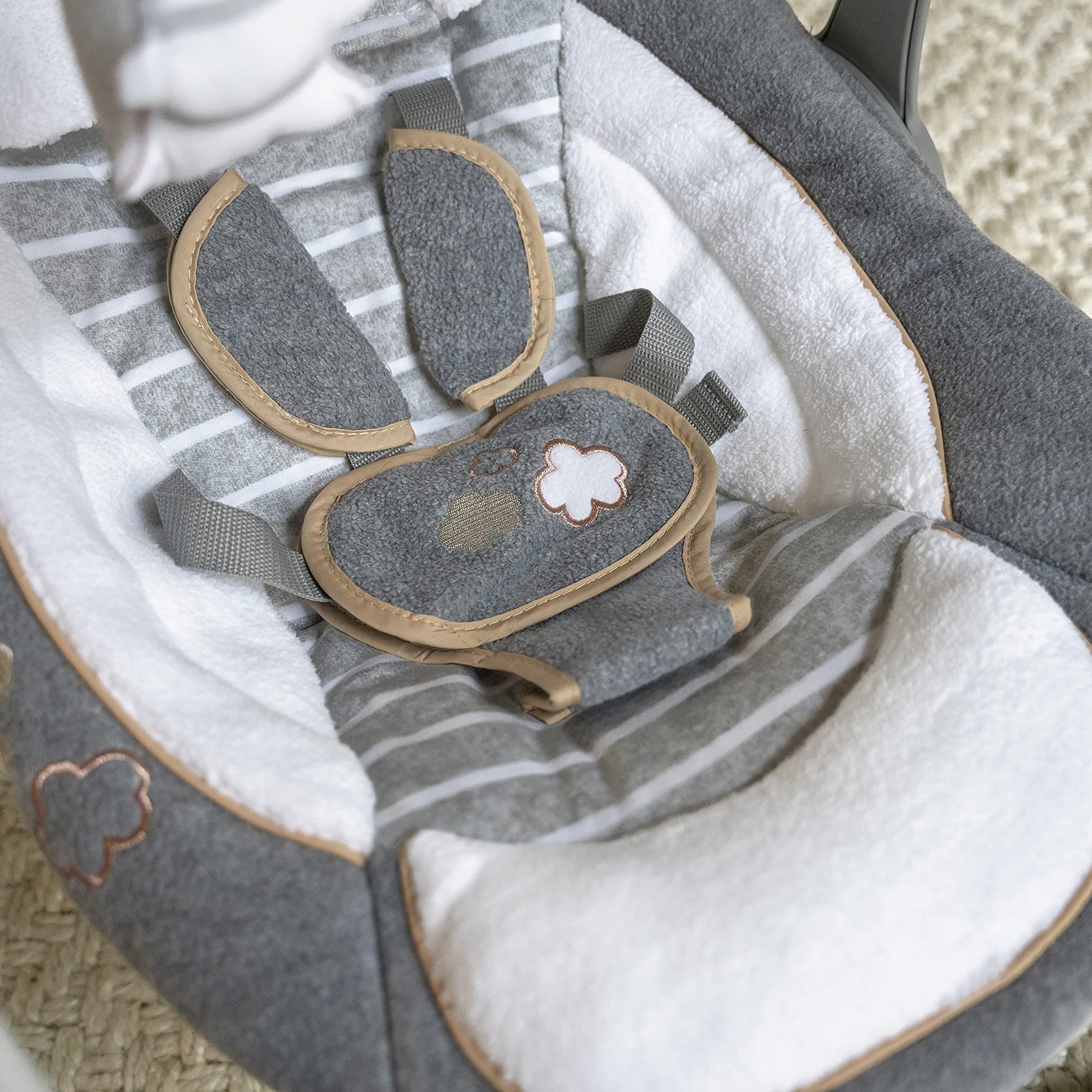 Ingenuity Swing 'n Go Deluxe baby swing with plush toys, cushioned harness, foldable design, and sound features for infants 0-9 months.