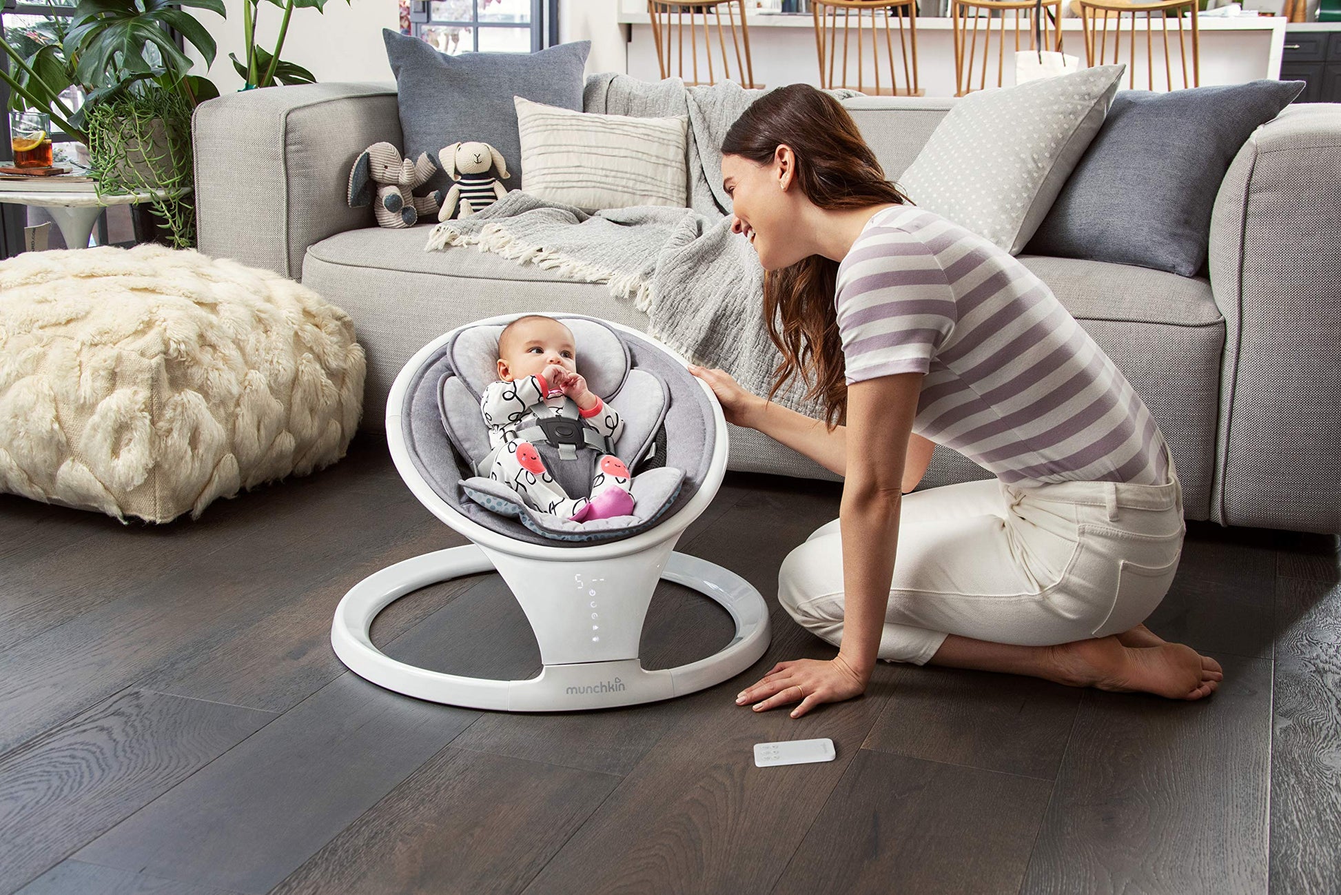 Munchkin electric baby swing in white with Bluetooth, portable bouncer chair featuring gentle bouncing, motion, and sound functionality.