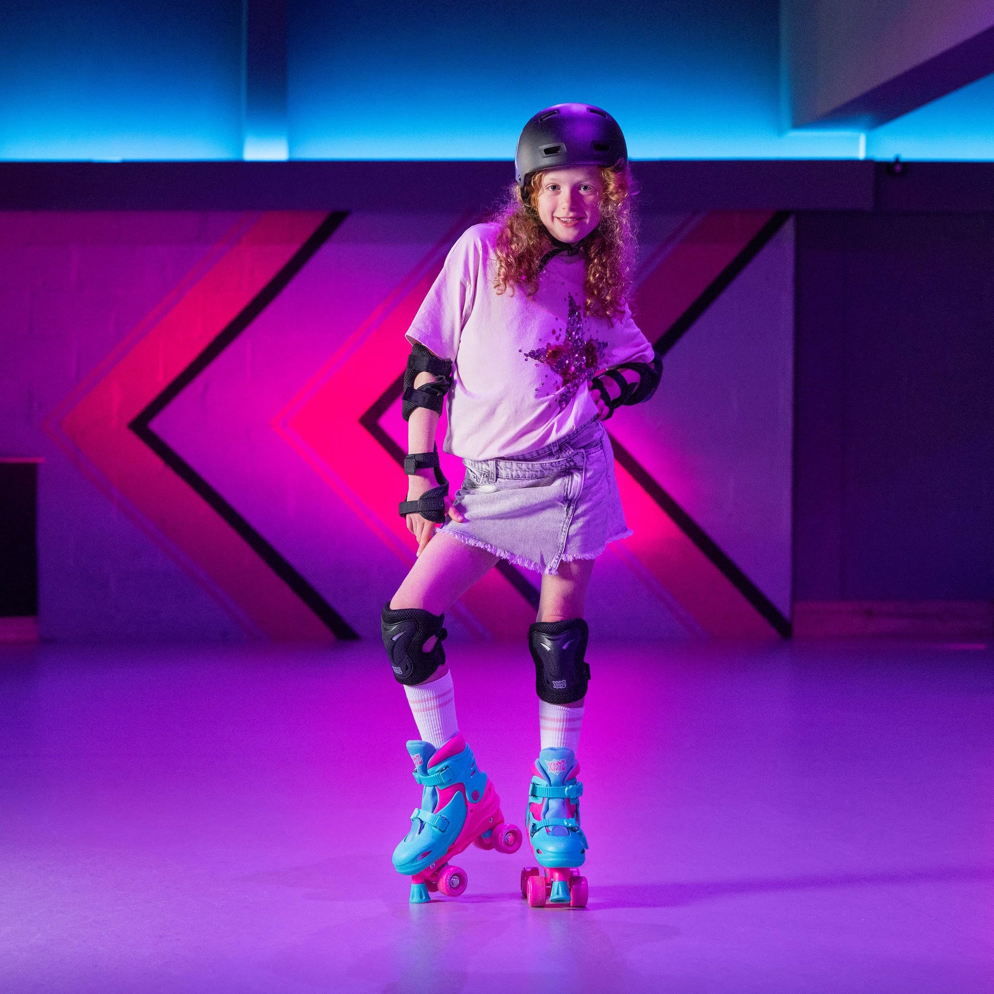 Pink Xootz kids quad roller skates for girls, adjustable beginner skates with four wheels and pink accents.