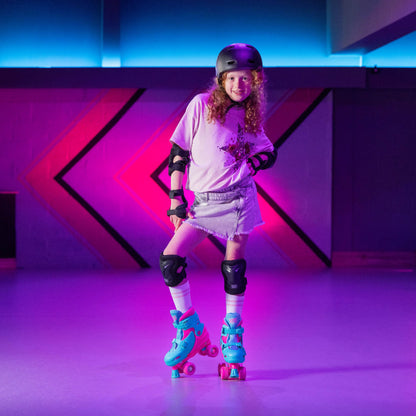 Pink Xootz kids quad roller skates for girls, adjustable beginner skates with four wheels and pink accents.