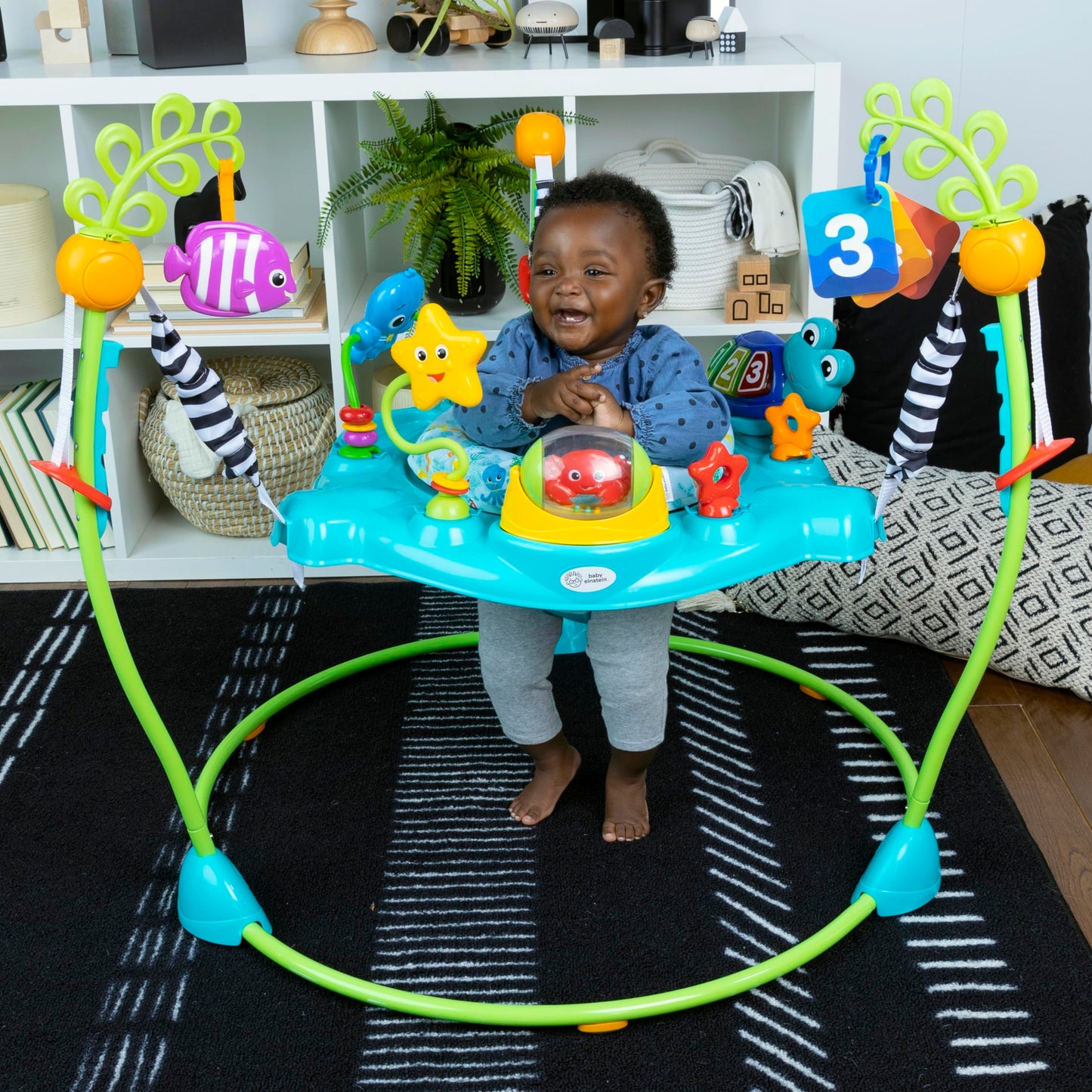 Baby Einstein Ocean Explorers Curiosity Cove 2-in-1 activity jumper and floor toy for babies 6-12 months, with colorful ocean-themed features.
