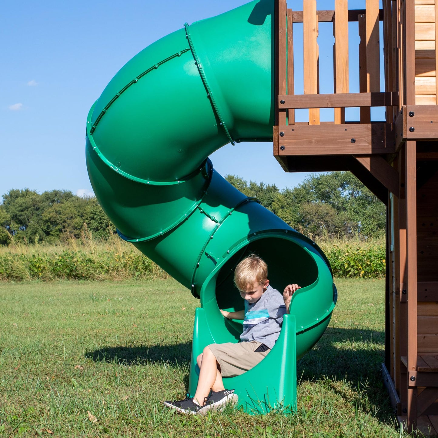 Backyard Discovery Cedar Cove cedar wood swing set with wave slide, climbing wall, belt swings, and web disc for kids' outdoor play.