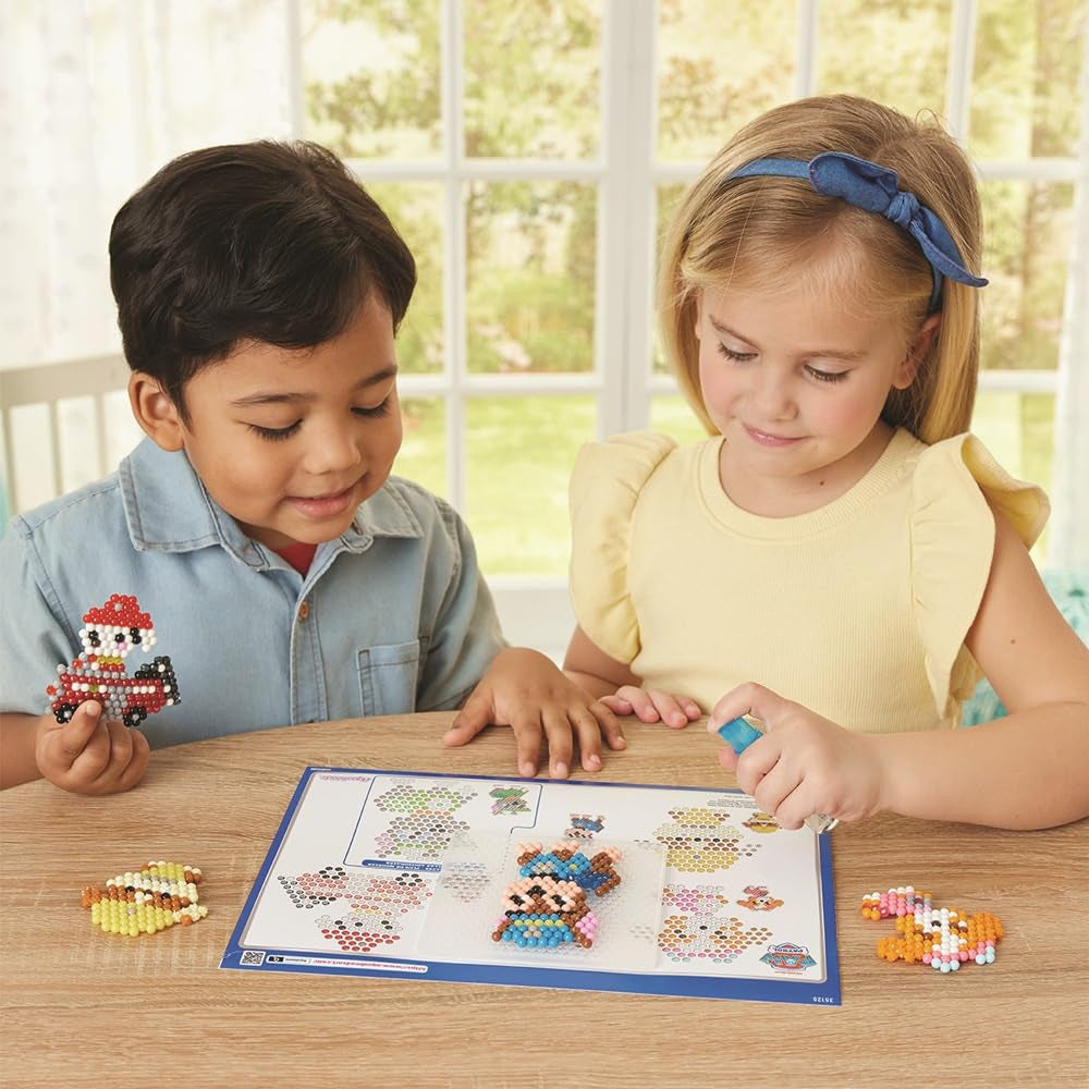 Aquabeads Paw Patrol keychain craft kit with colorful beads and accessories for creating themed keychains and jewelry.