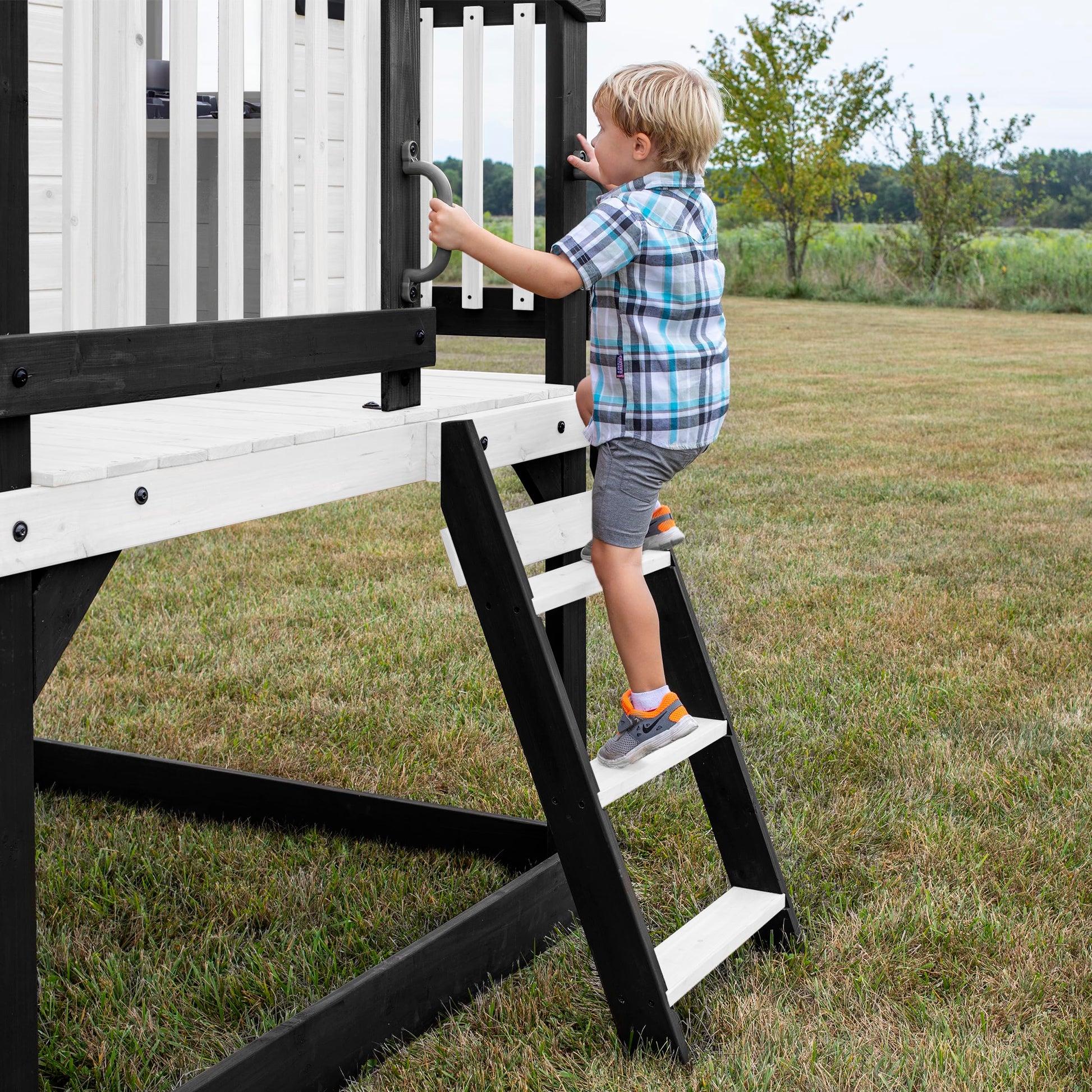Backyard Discovery Sweetwater Heights cedar wood elevated playhouse with wave slide, toy kitchen, and growth chart for kids' outdoor play area.