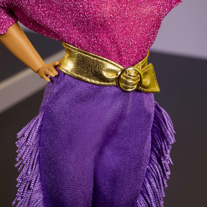 Barbie Signature Debbie Allen Tribute Doll in off-shoulder top, gold belt, purple fringe pants, and leg warmers.