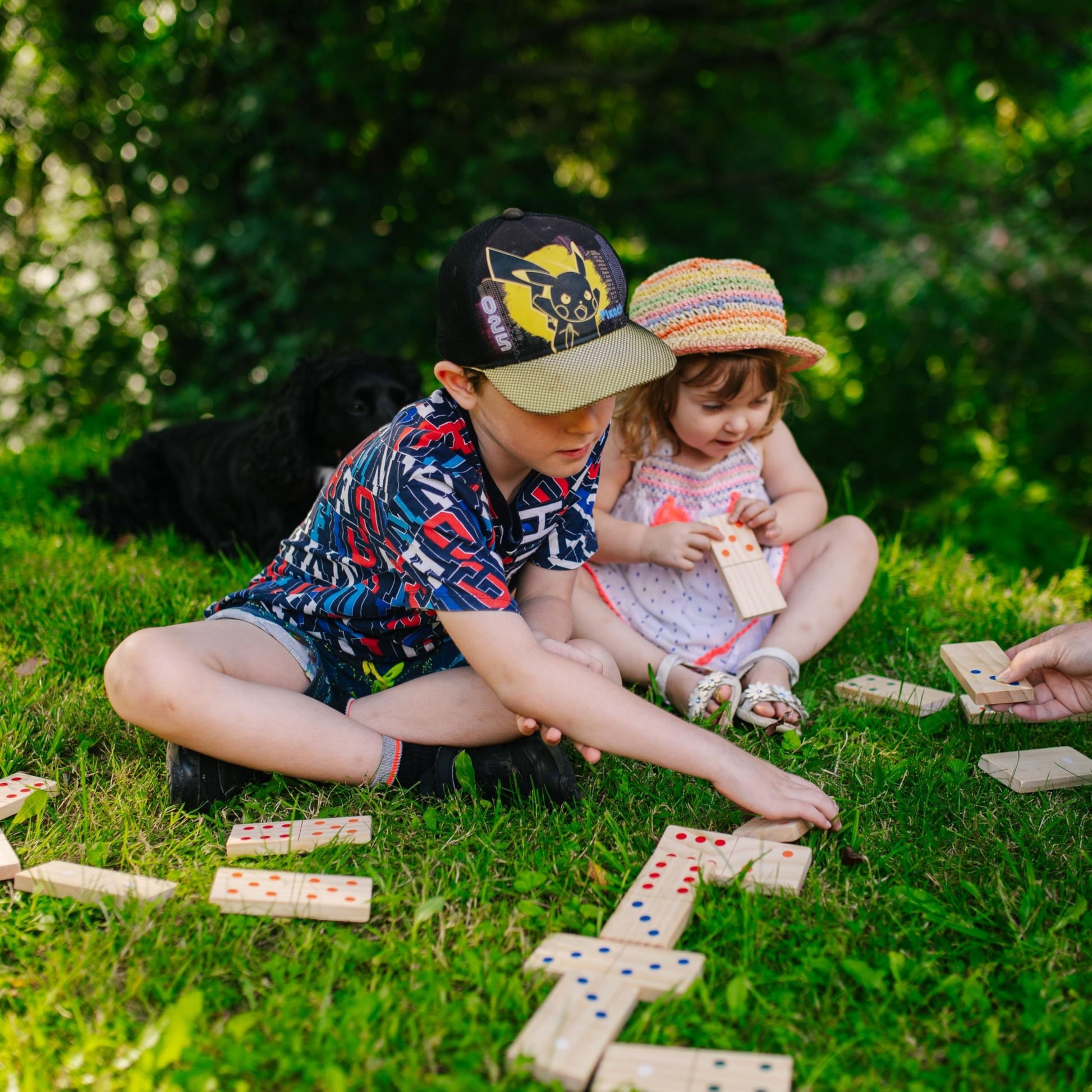 Wooden giant dominoes set by Jaques of London for kids, ideal for outdoor garden games and family fun.